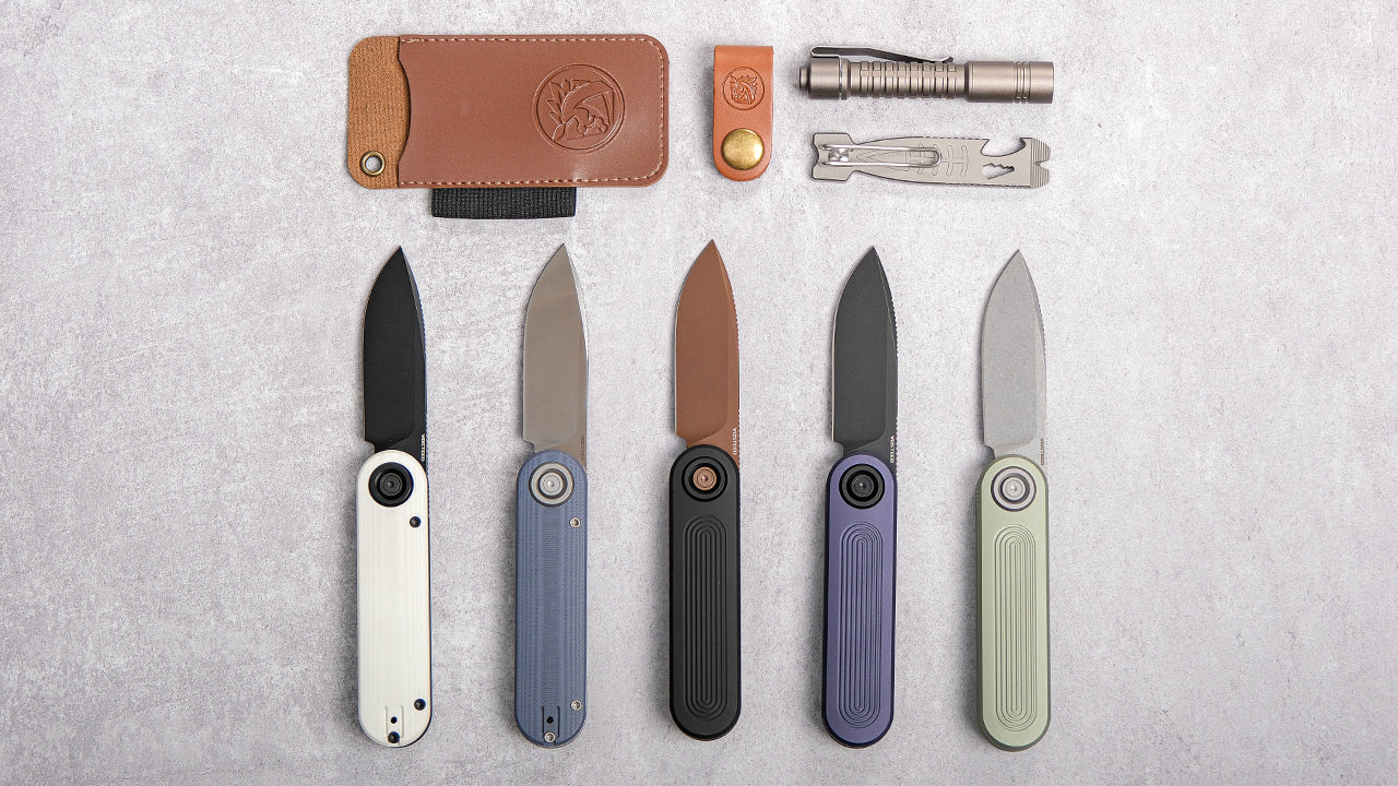 A stylish collection of modern folding knives arranged neatly on a light gray background, showcasing various handle colors including white, blue, black, purple, and light green