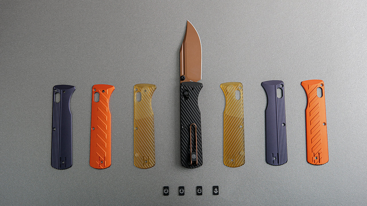 An assembled pocket knife with a copper blade and black handle, surrounded by a variety of colorful replacement scales in orange, blue, and translucent yellow, highlighting customization options