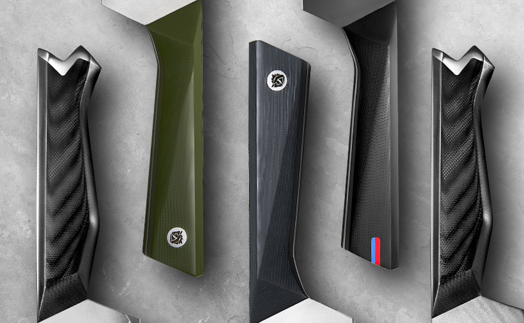 Collection of modern knife handles in different materials including G10 in black and green, displayed against a gray concrete background