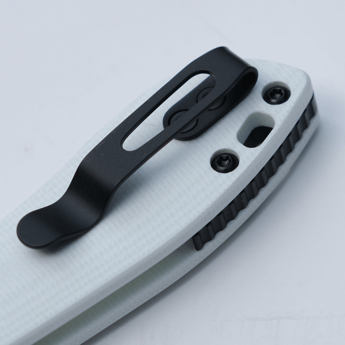 Vosteed Mini Nightshade knife detail - black pocket clip on white G10 handle