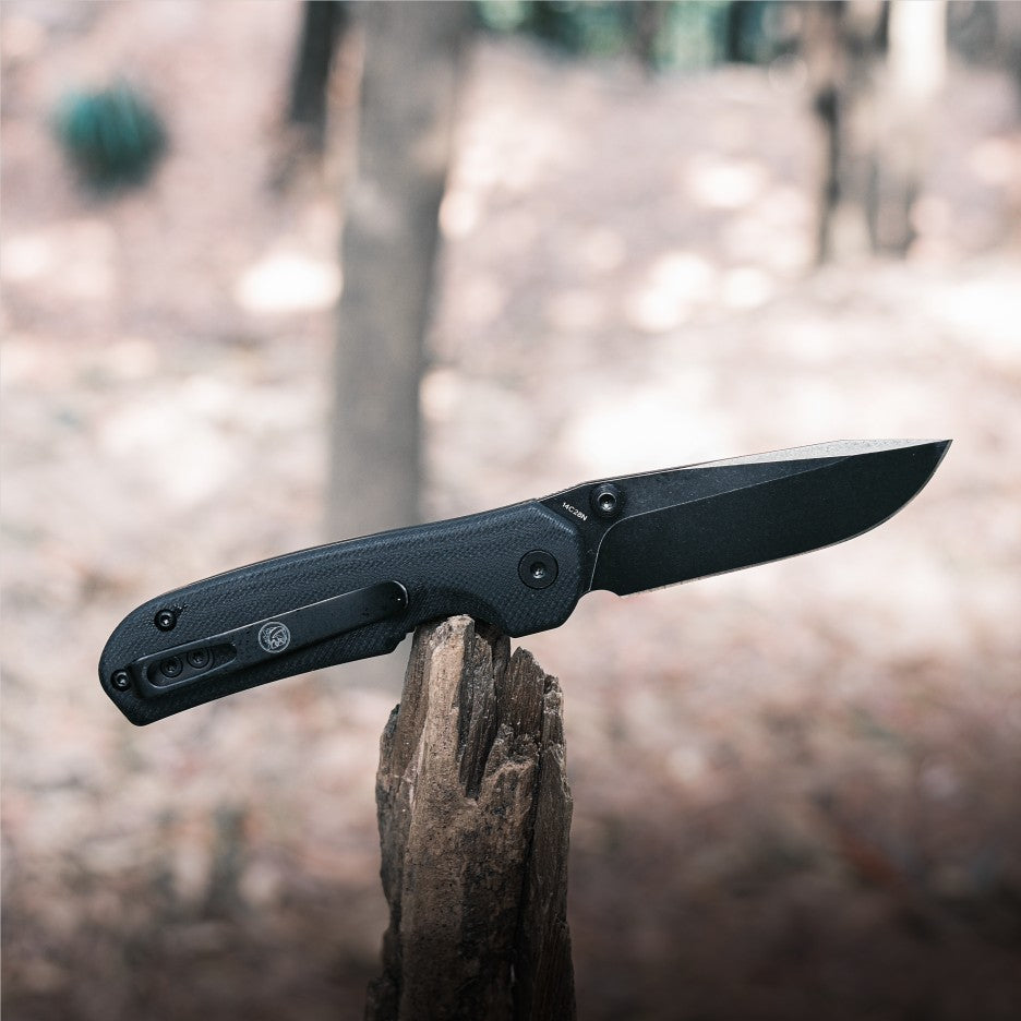 Vosteed Chipmunk knife, black blade, on wood, outdoor