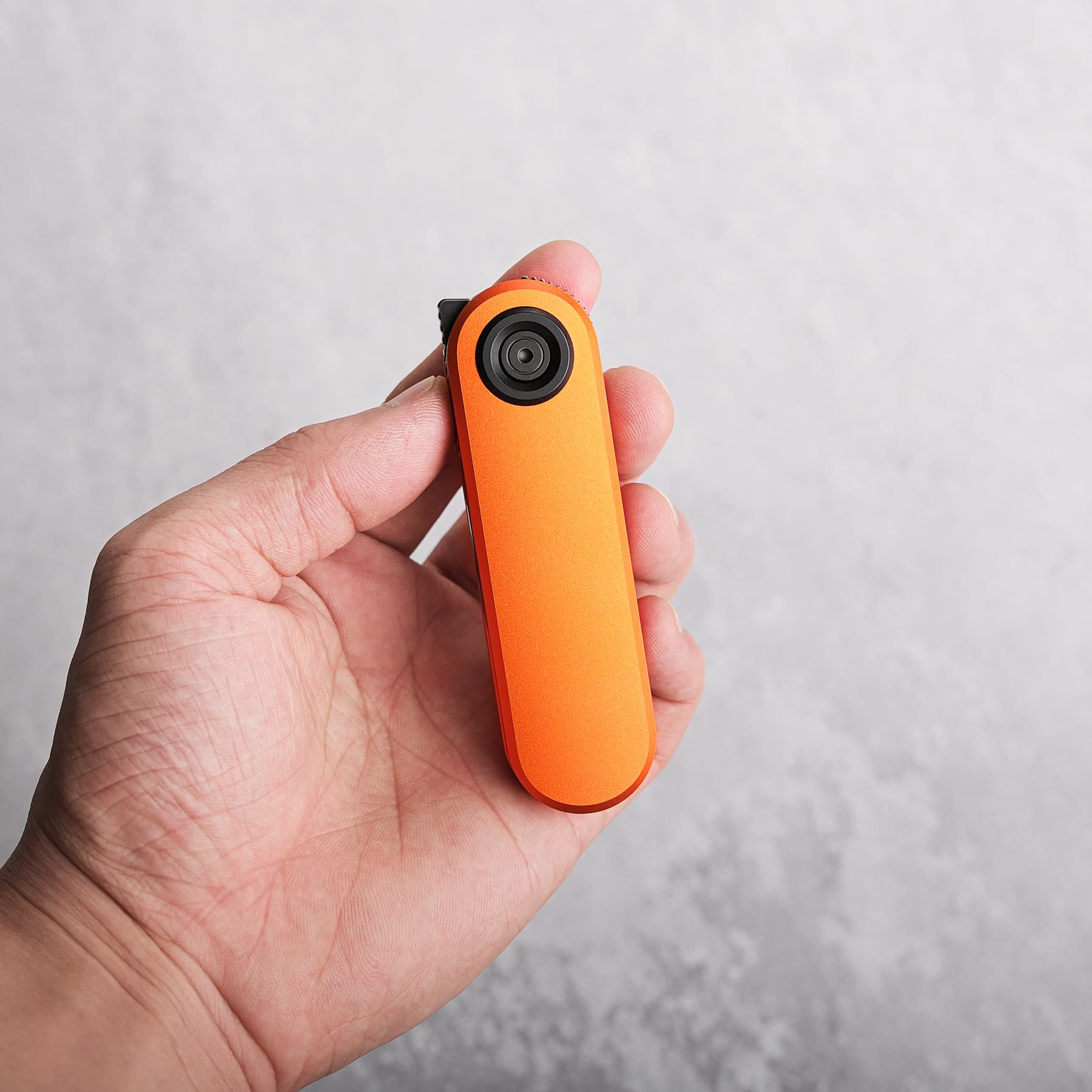 Corgi V knife held in hand, orange handle