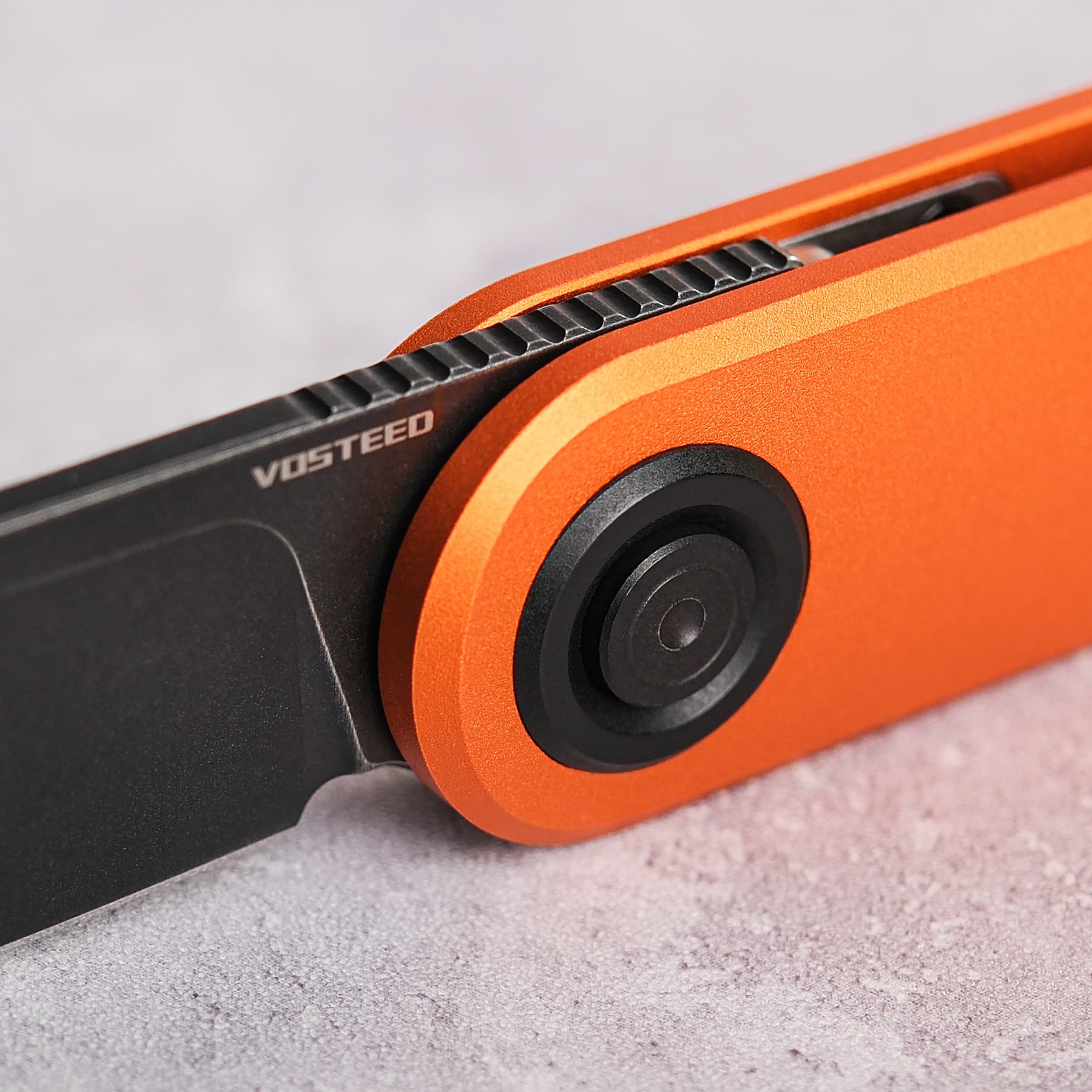 Vosteed Corgi V knife close-up: Vanchor Lock, orange handle