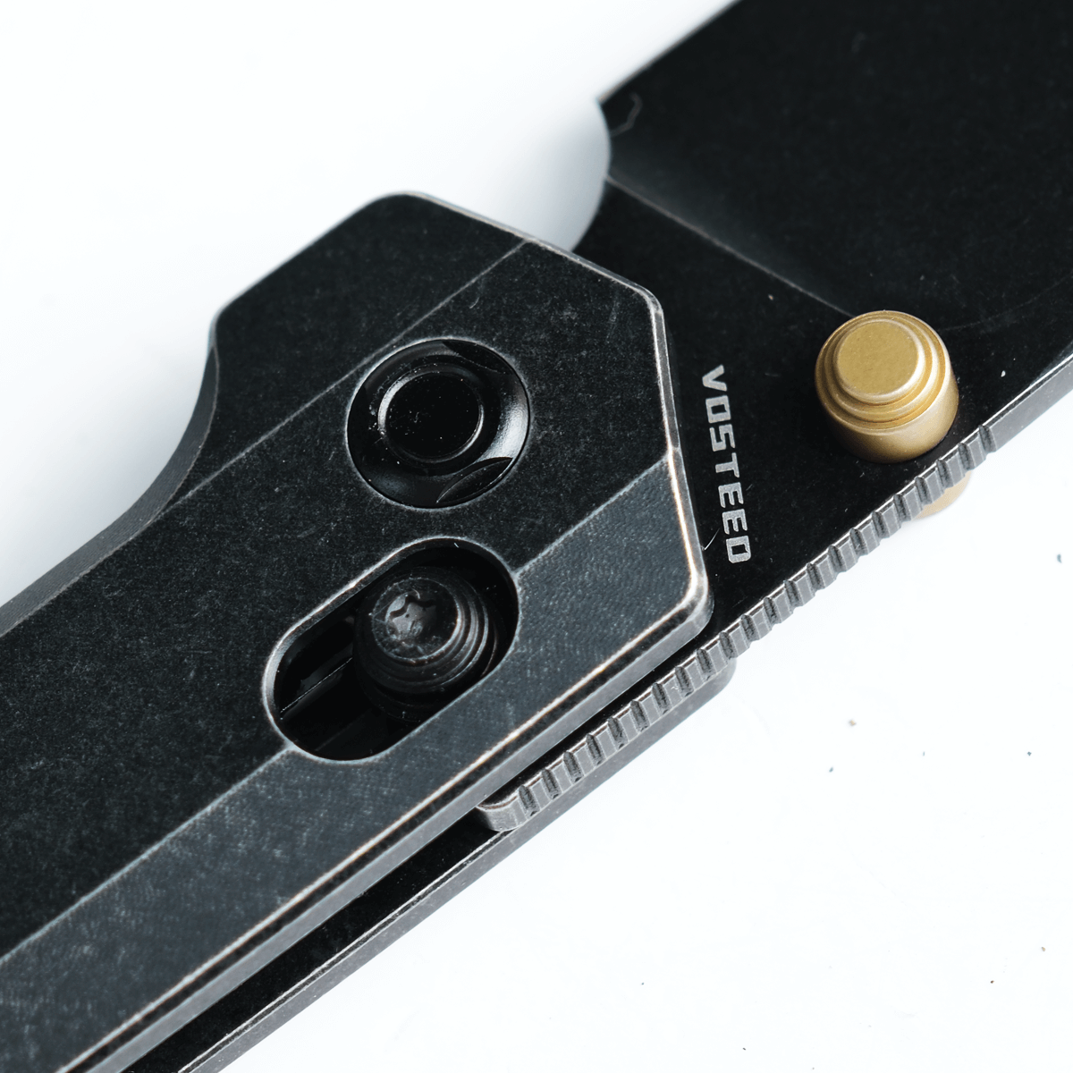 Vosteed Dachshund knife detail: black titanium handle and blade, Vosteed logo