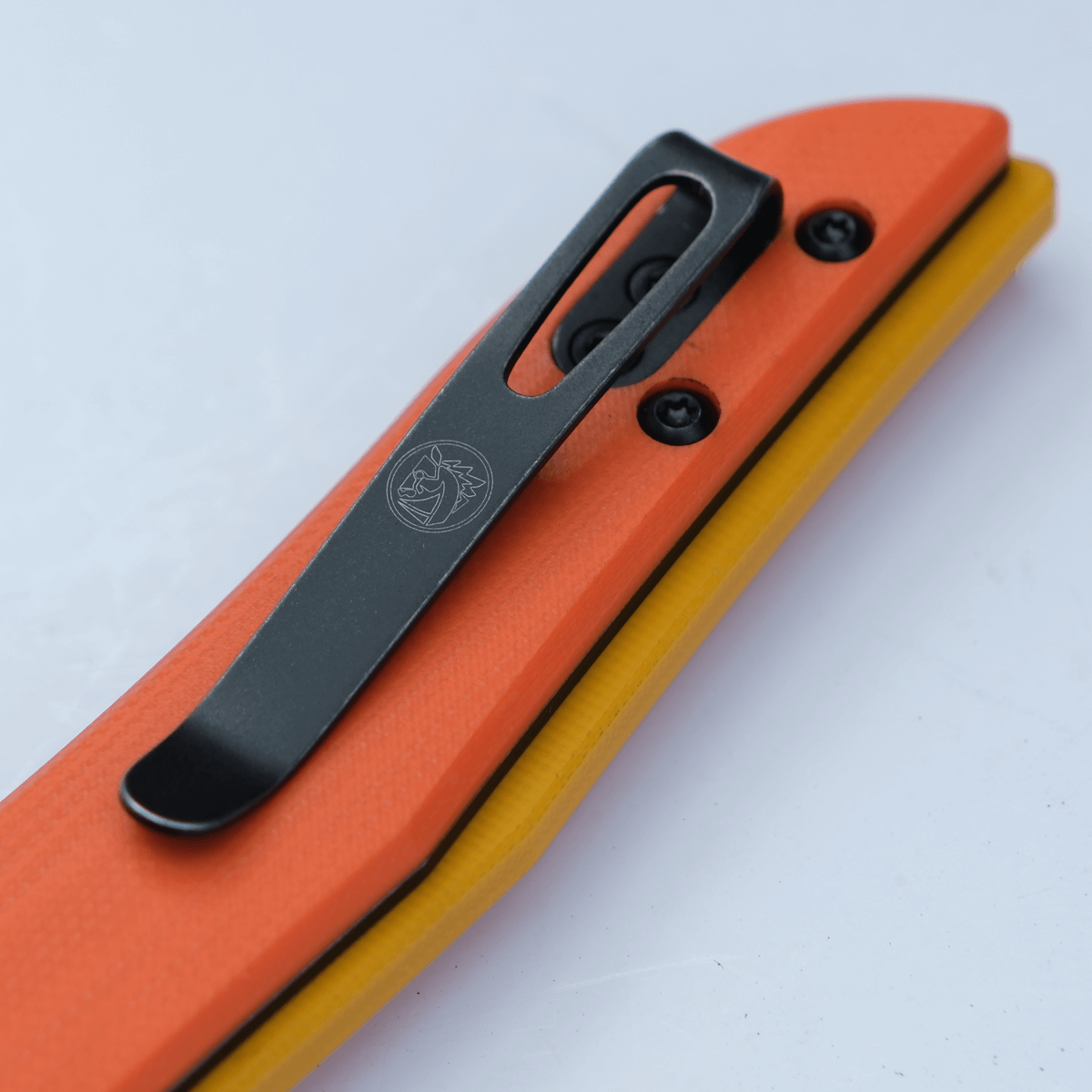 Vosteed Griffin knife pocket clip detail, orange G10 handle