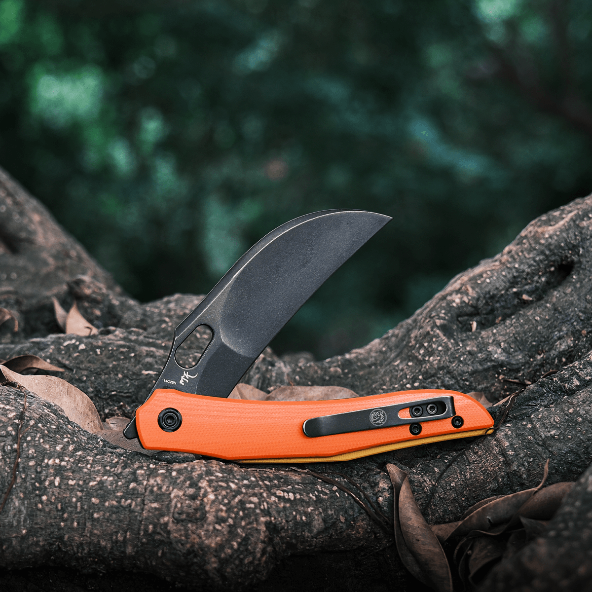 Vosteed Griffin Hawkbill Knife - Orange G10 on a Tree Trunk