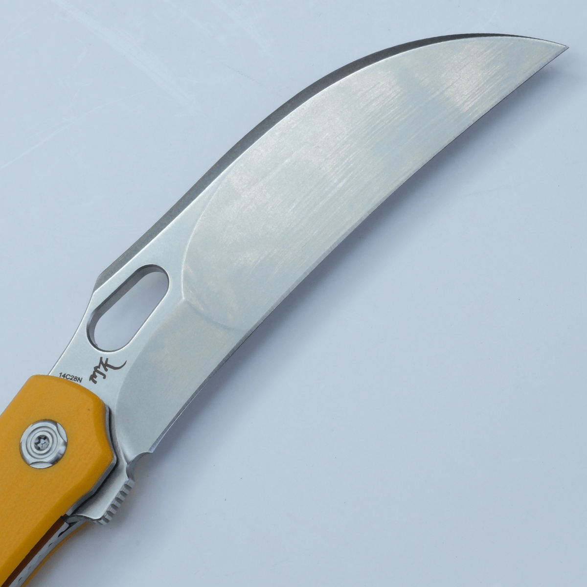 Vosteed Griffin knife detail: hawkbill blade and yellow handle.
