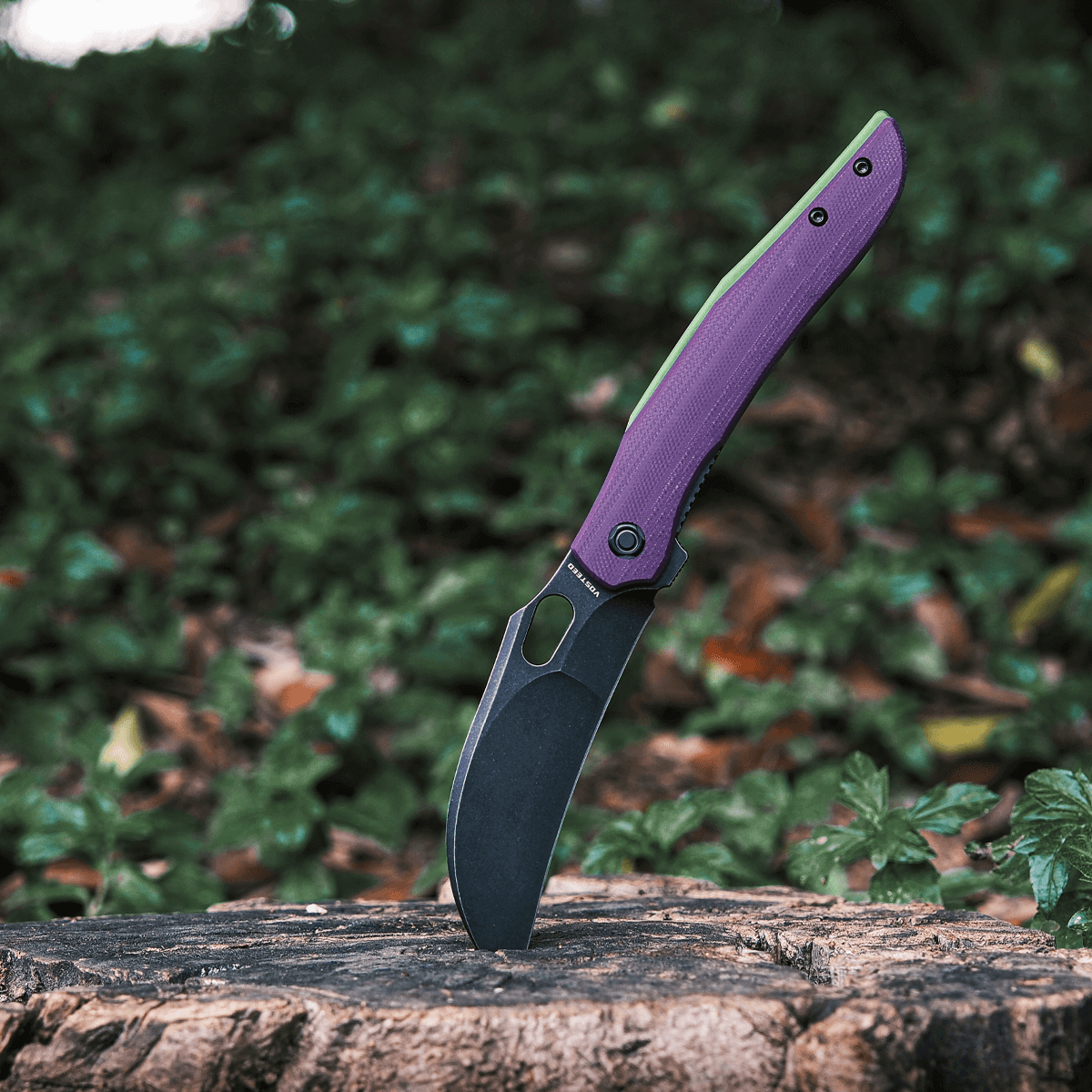 Vosteed Griffin hawkbill knife standing on wood, purple G10 handle
