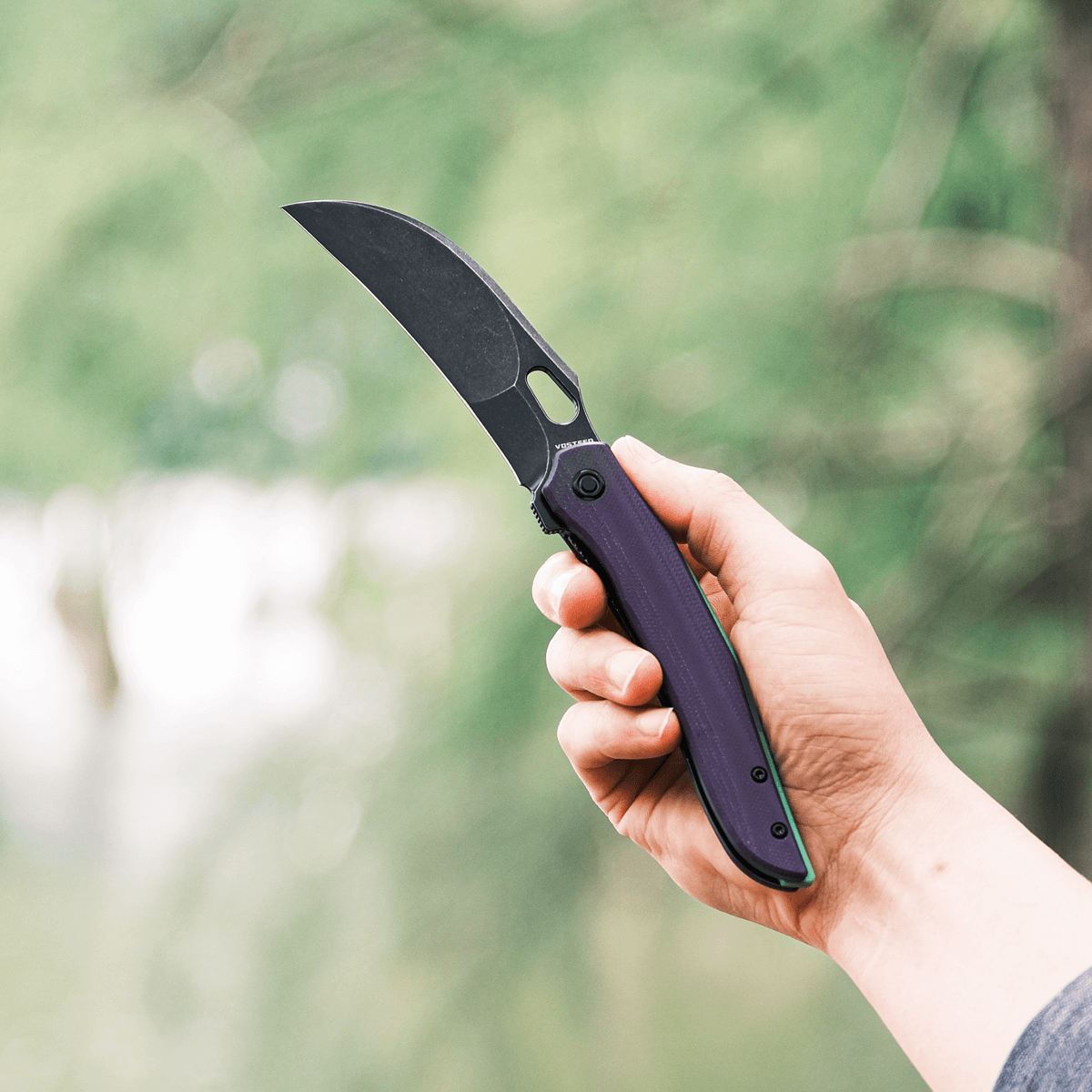 Vosteed Griffin knife in hand, purple G10 handle