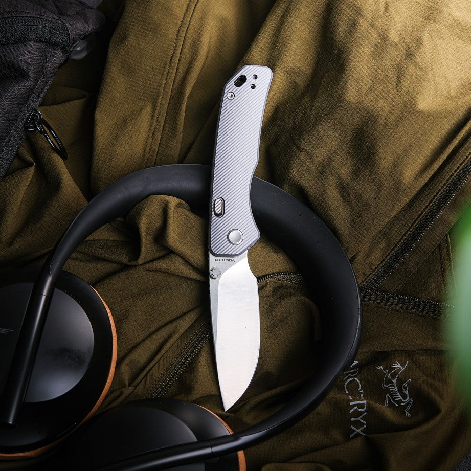Vosteed Marten knife, EDC knife, sitting with headphones and jacket