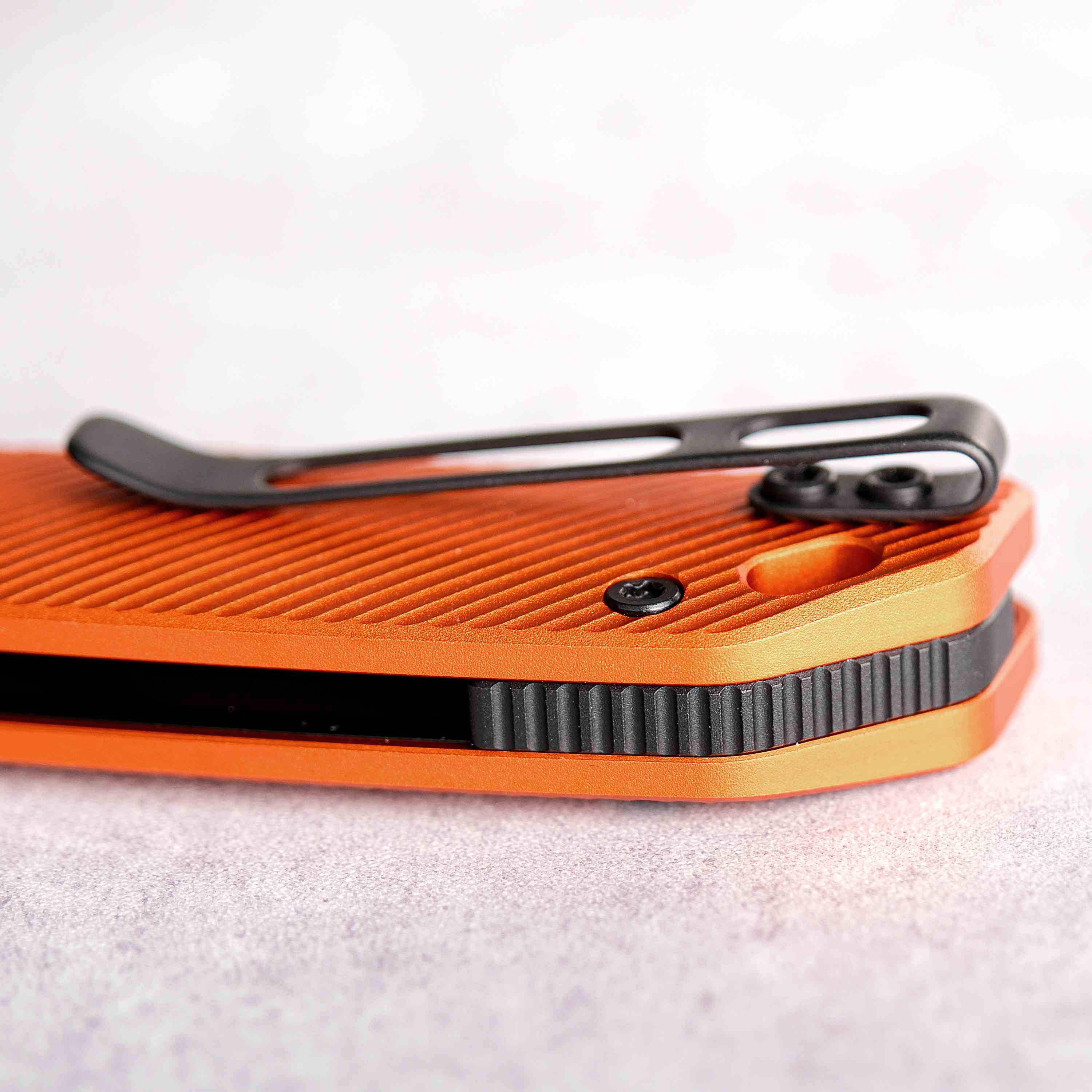 Vosteed Marten knife, close-up of orange aluminum handle and pocket clip