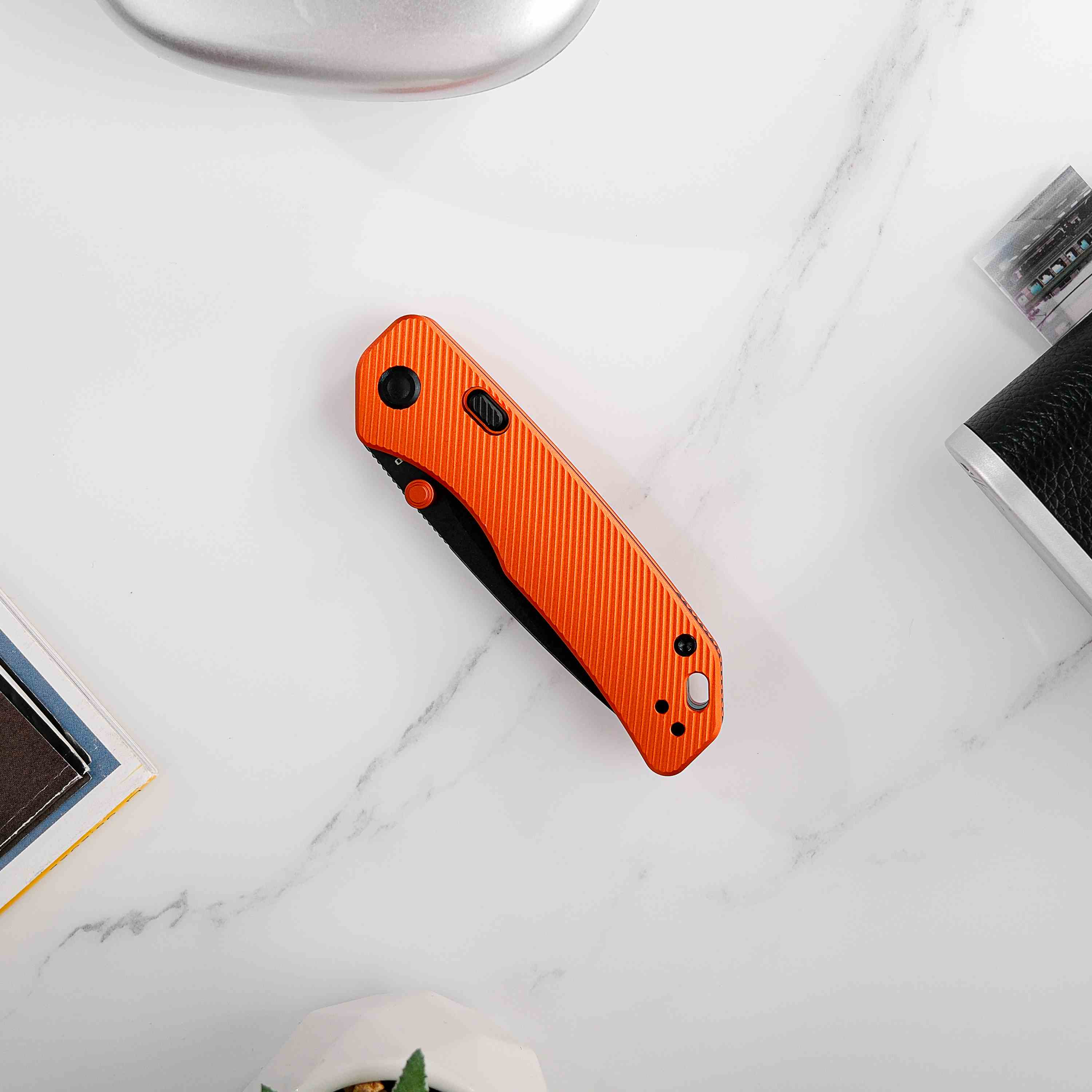 Vosteed Marten knife orange handle on marble, EDC knife product shot