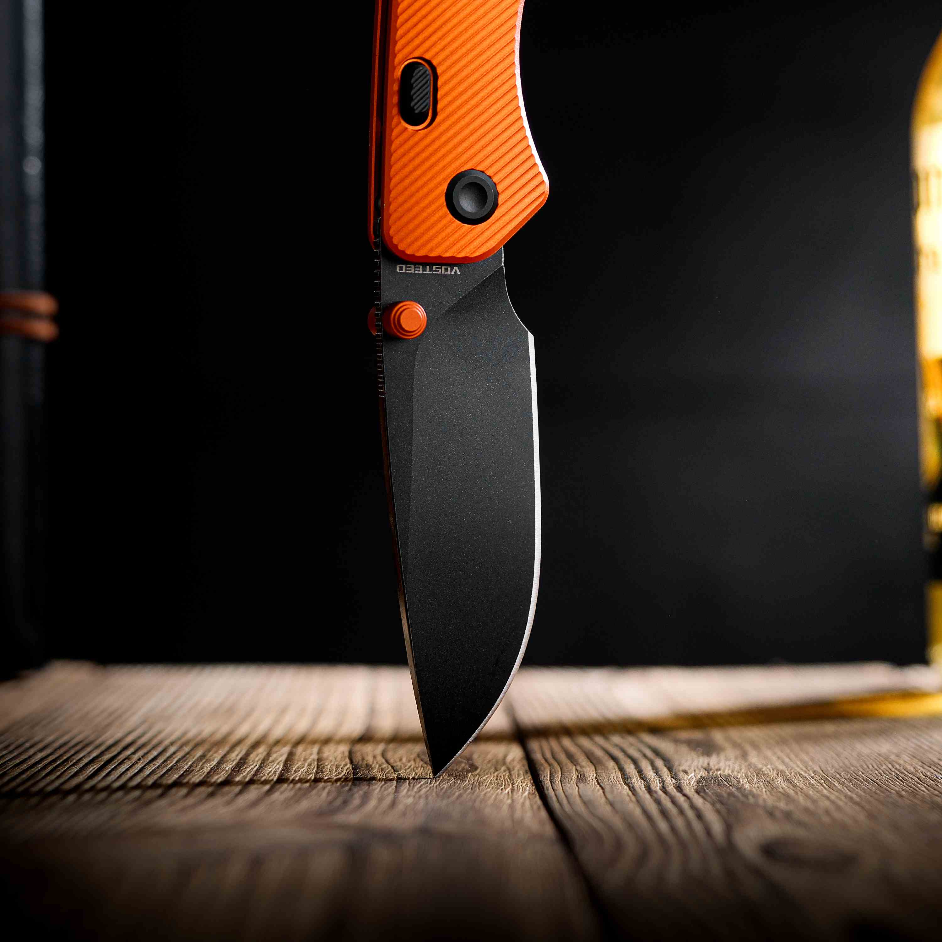 Vosteed Marten knife, black blade and orange handle.