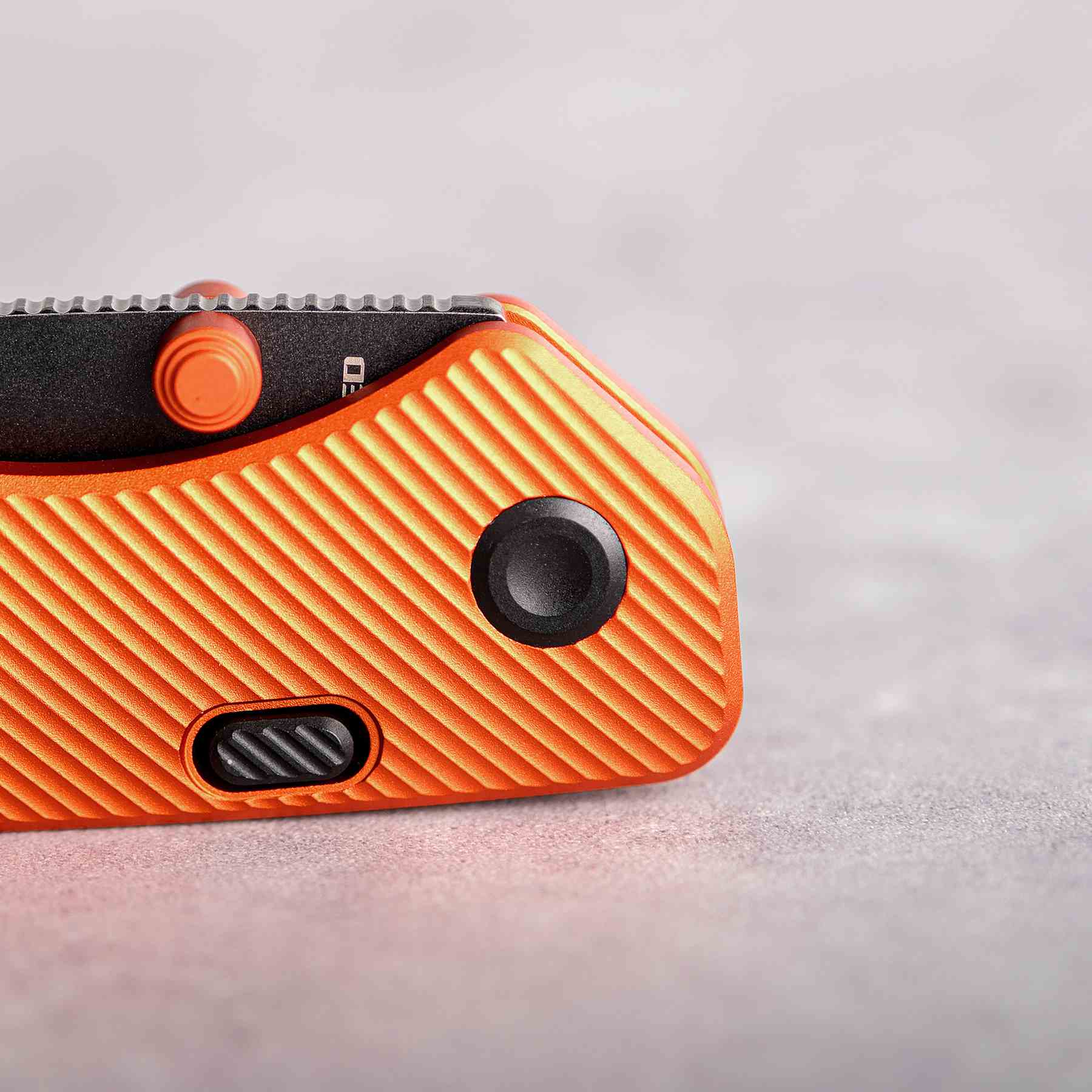 Vosteed Marten knife detail: Orange handle with button lock