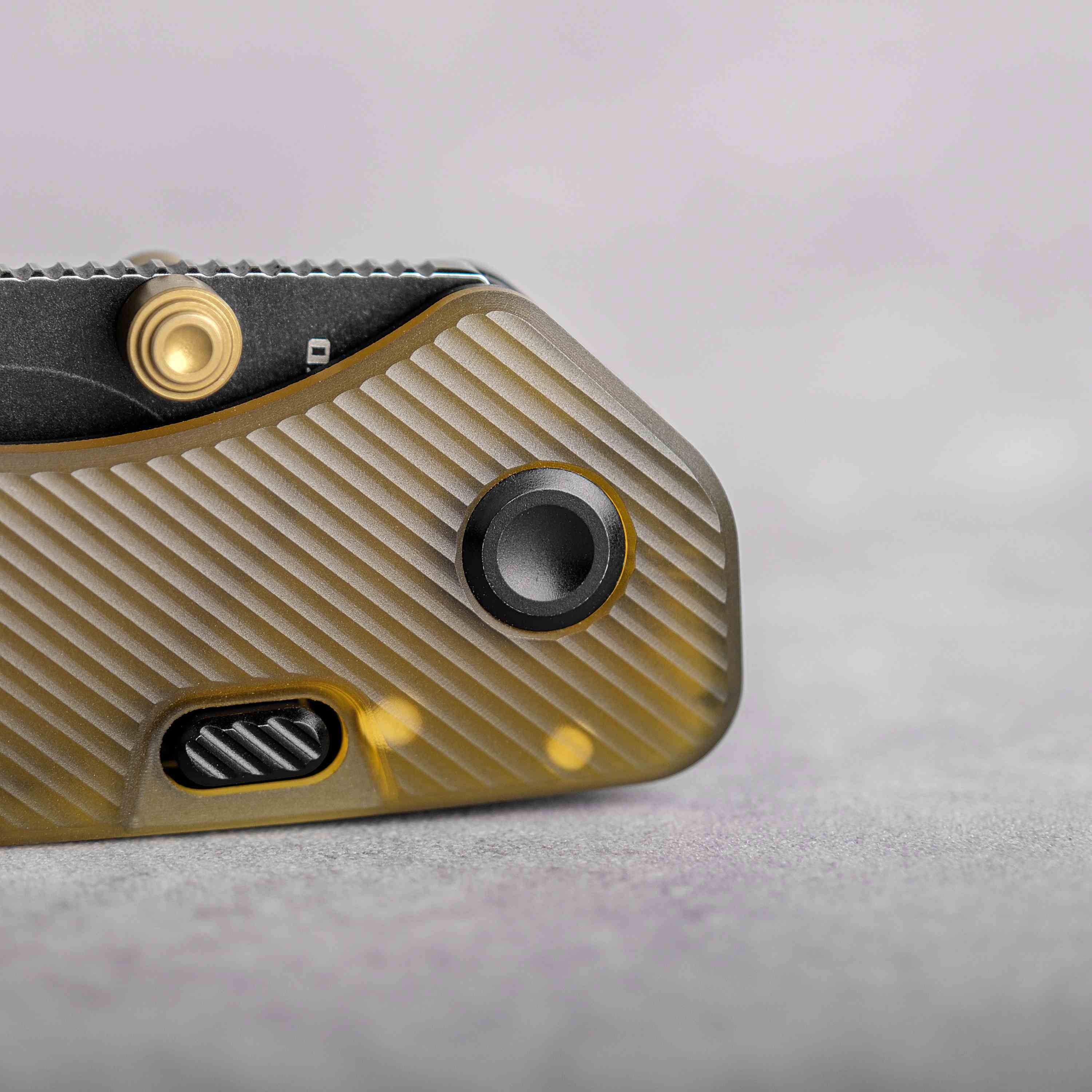 Vosteed Marten knife detail: Button lock and amber PEI handle