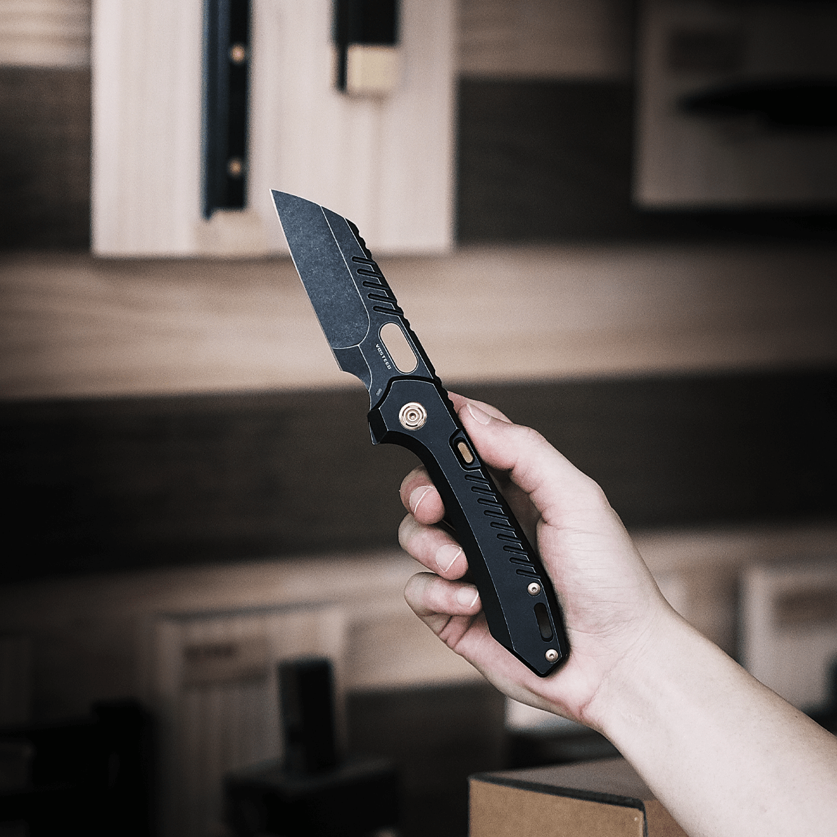 Vosteed RSKAOS knife held in hand, black M390 blade