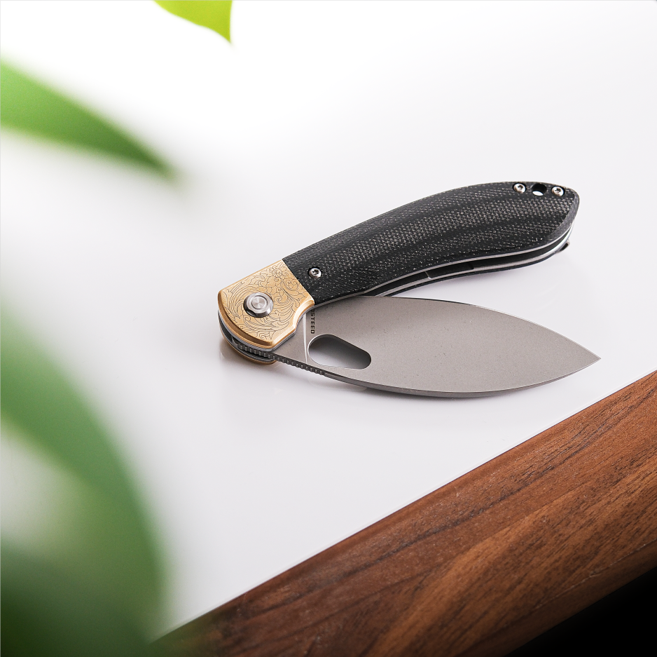 Vosteed Nightshade knife, open blade, brass bolster detail