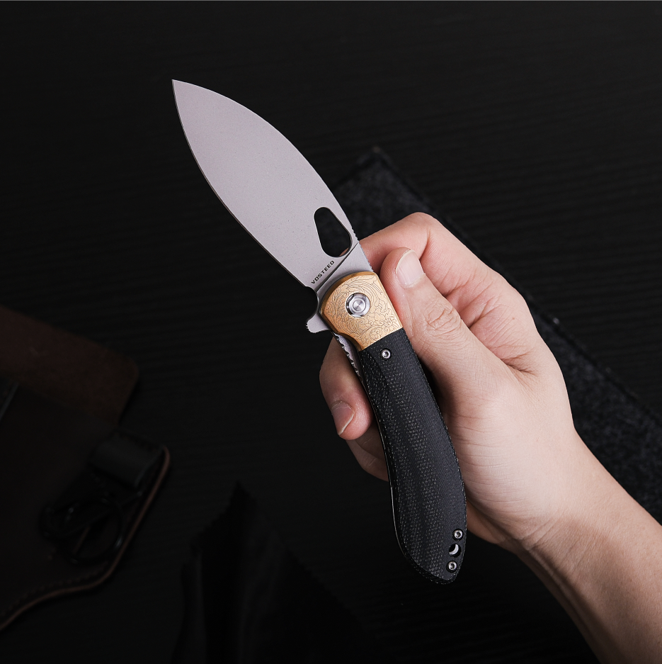 Vosteed Nightshade knife in hand, showcasing brass bolster detail