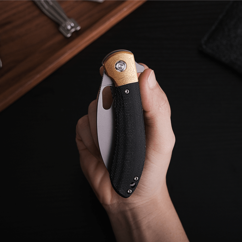 Vosteed Nightshade knife held in hand, brass bolster detail