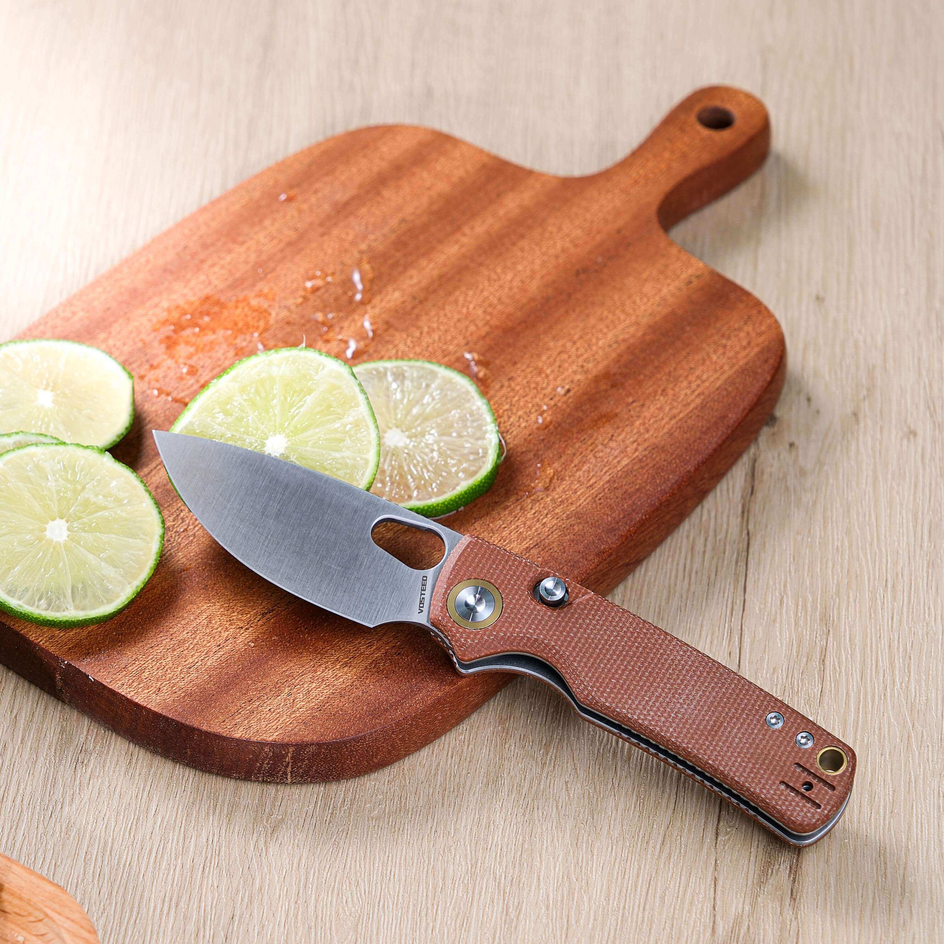 Vosteed Porcupine knife slicing limes on a cutting board