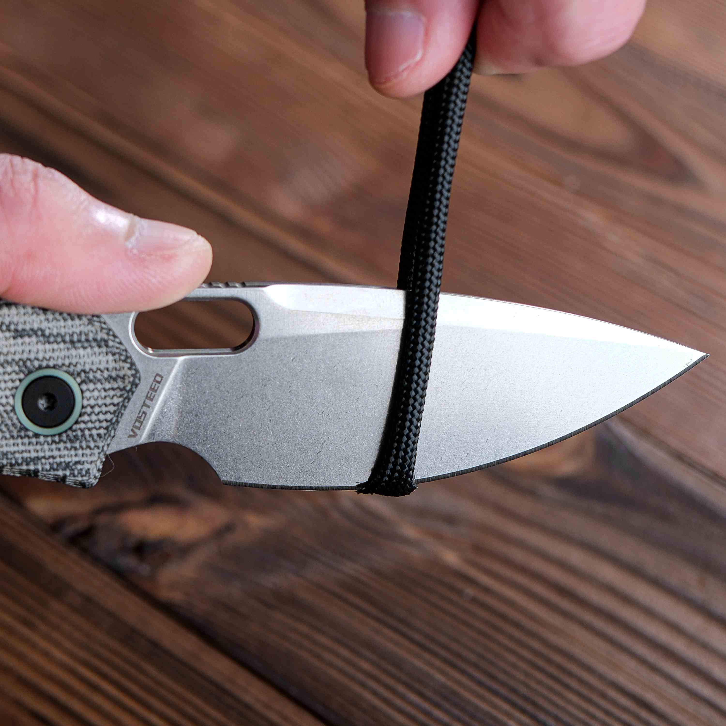 Vosteed Psyop knife blade cutting a black rope