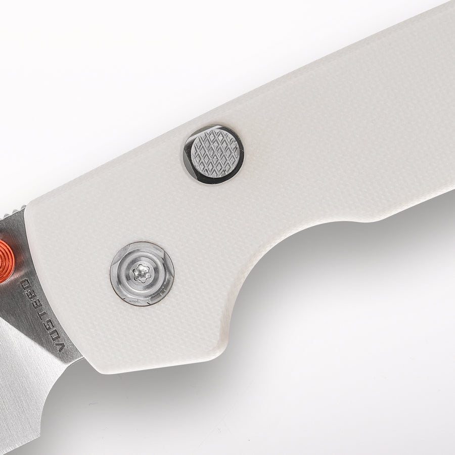 Vosteed Raccoon knife close-up: G10 handle detail and button