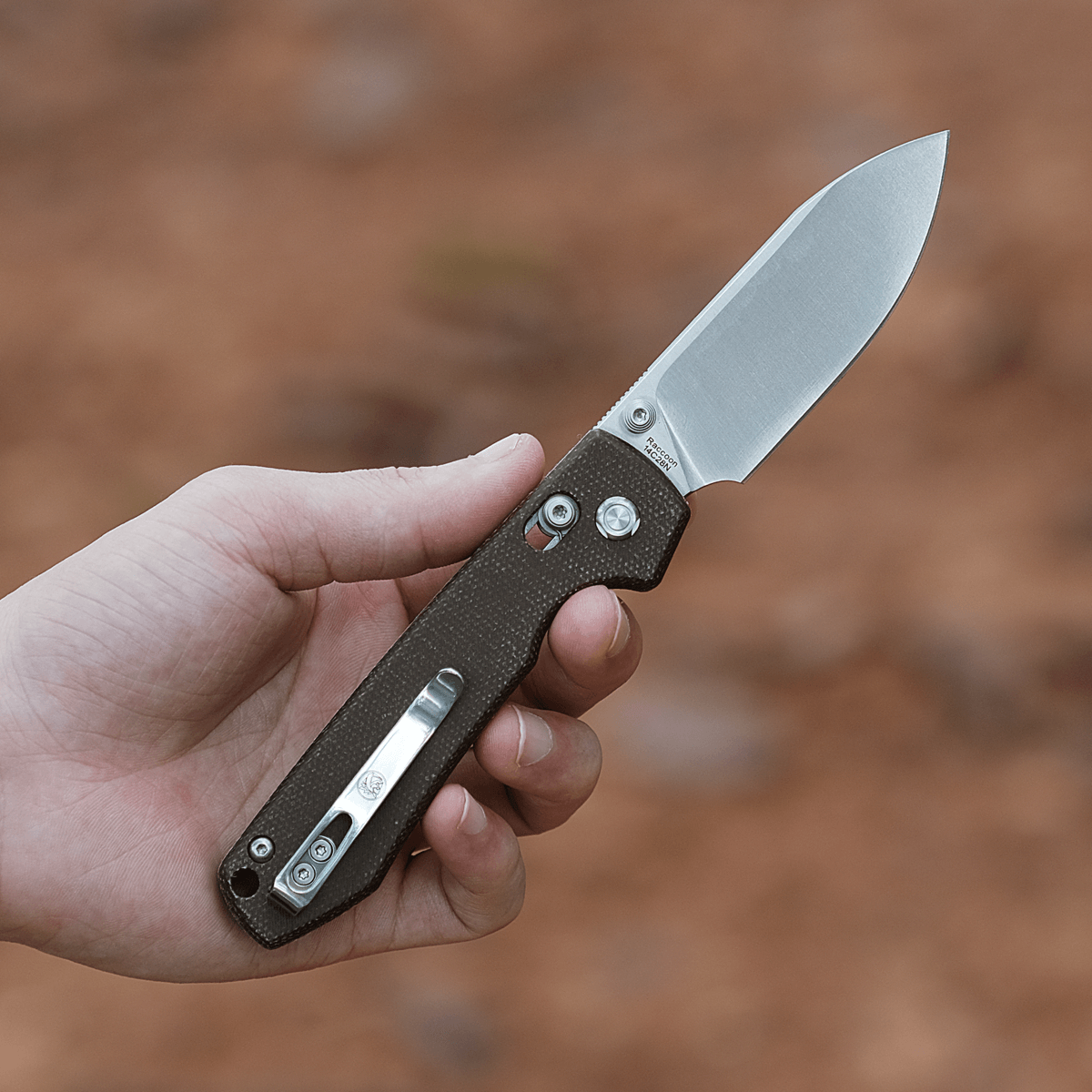 Vosteed Raccoon Crossbar Lock knife held in hand