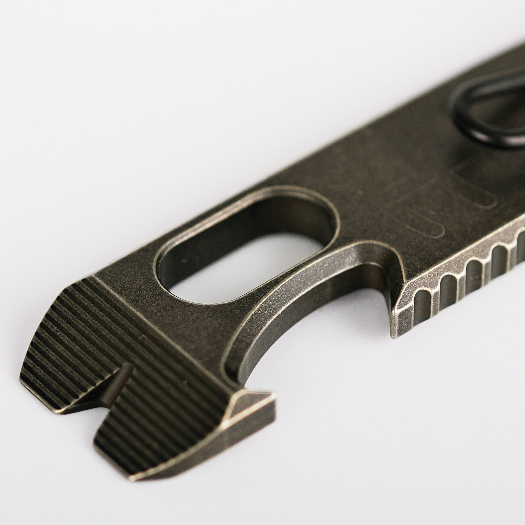 Shark Bomb Prybar close-up, showing bottle opener and jimping details.