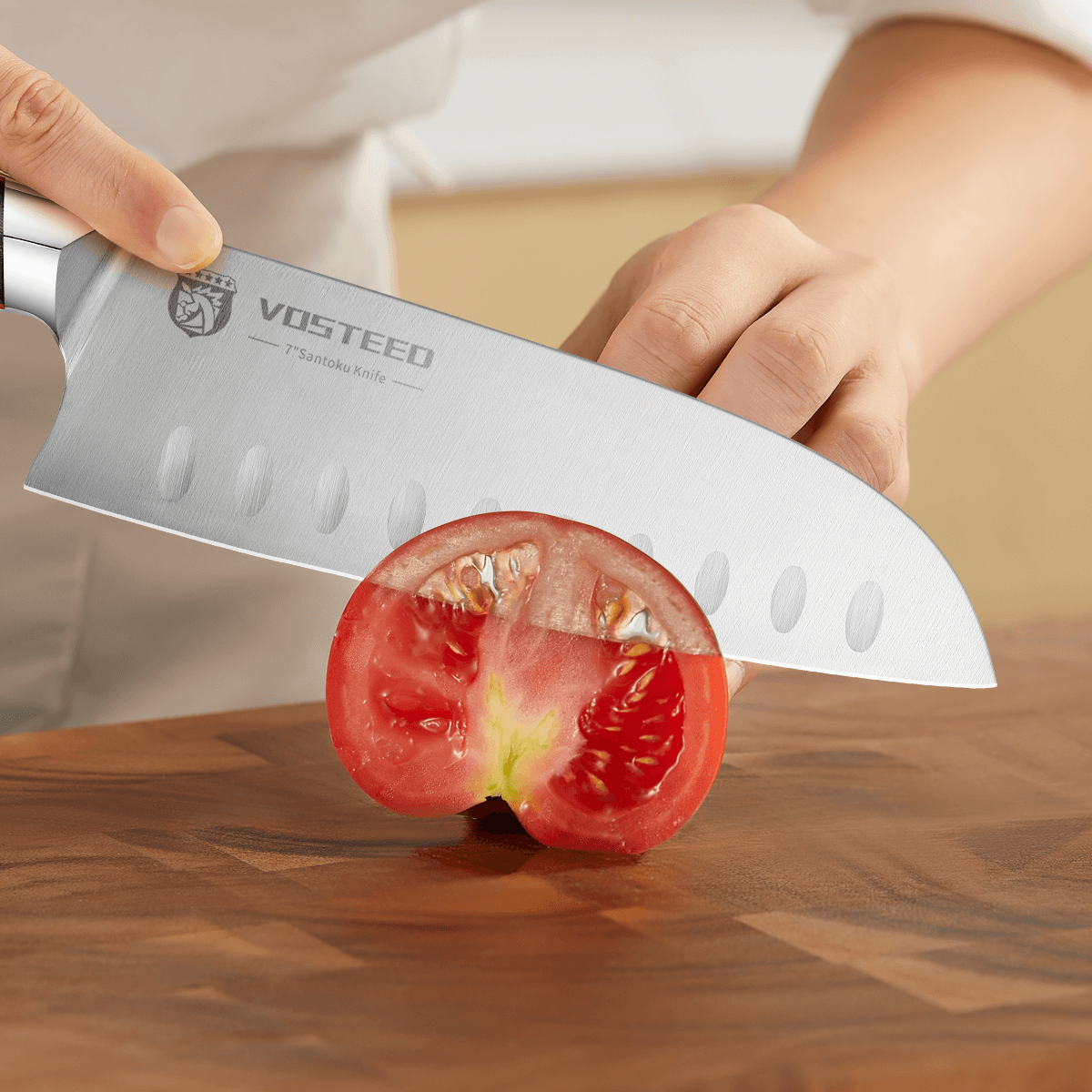 Vosteed Stallion Santoku Knife cutting a tomato on a wood cutting board