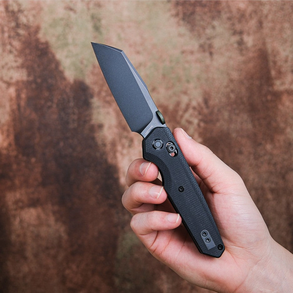 Vosteed Tala black knife held in hand, sheepsfoot blade
