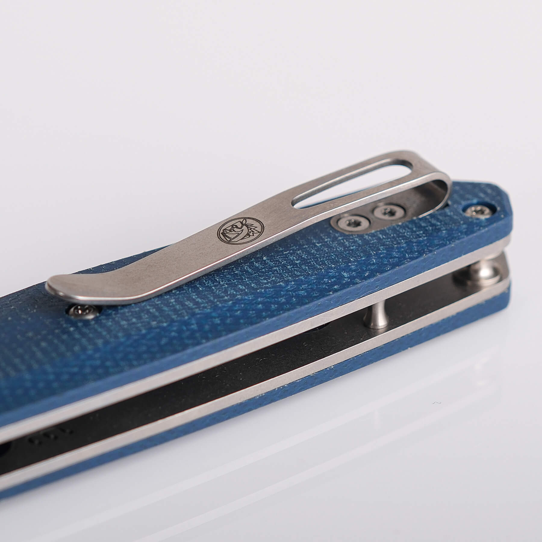 Vosteed Tala knife detail: pocket clip and blue Micarta handle