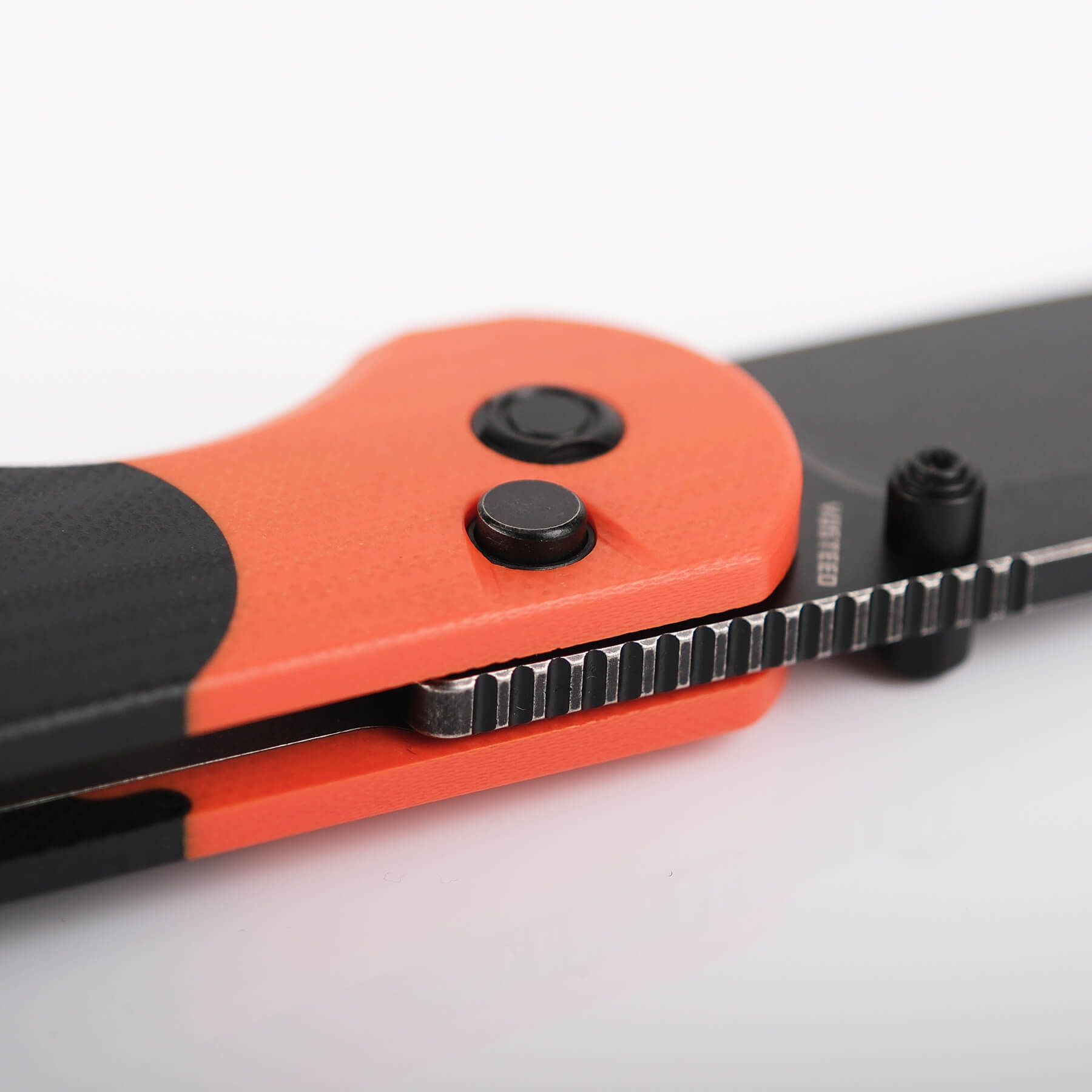 Vosteed Thornton knife orange G10 handle, Trek Lock button detail