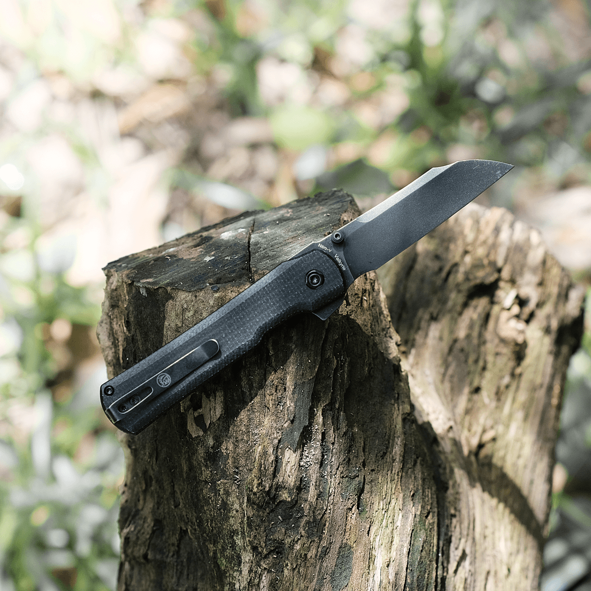 Vosteed Valkyrie Sheepsfoot blade knife on wooden stump