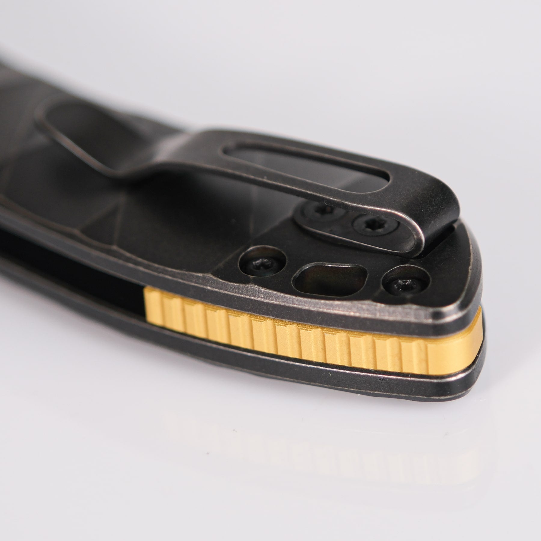 Mini Nightshade knife detail with golden backspacer and pocket clip
