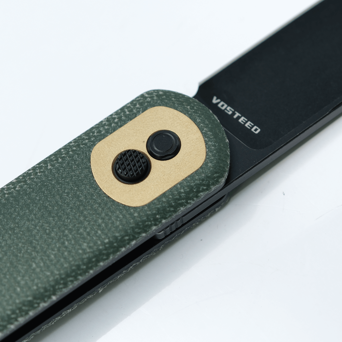 Vosteed Corgi knife detail, green Micarta handle, Trek Lock mechanism
