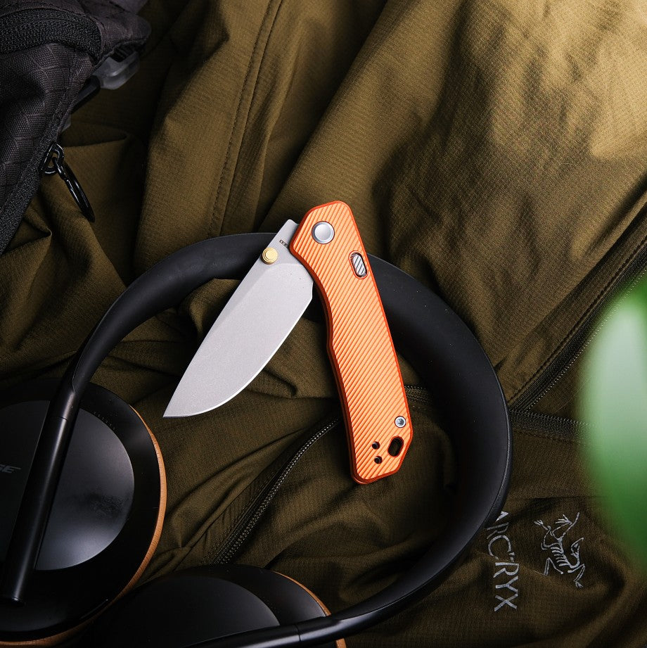 Vosteed Marten Knife on headphones and jacket