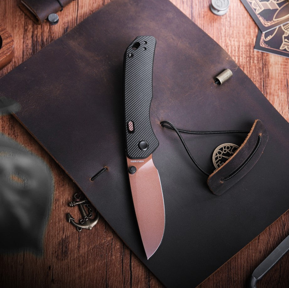 Vosteed Marten knife open on leather journal - Product lifestyle shot