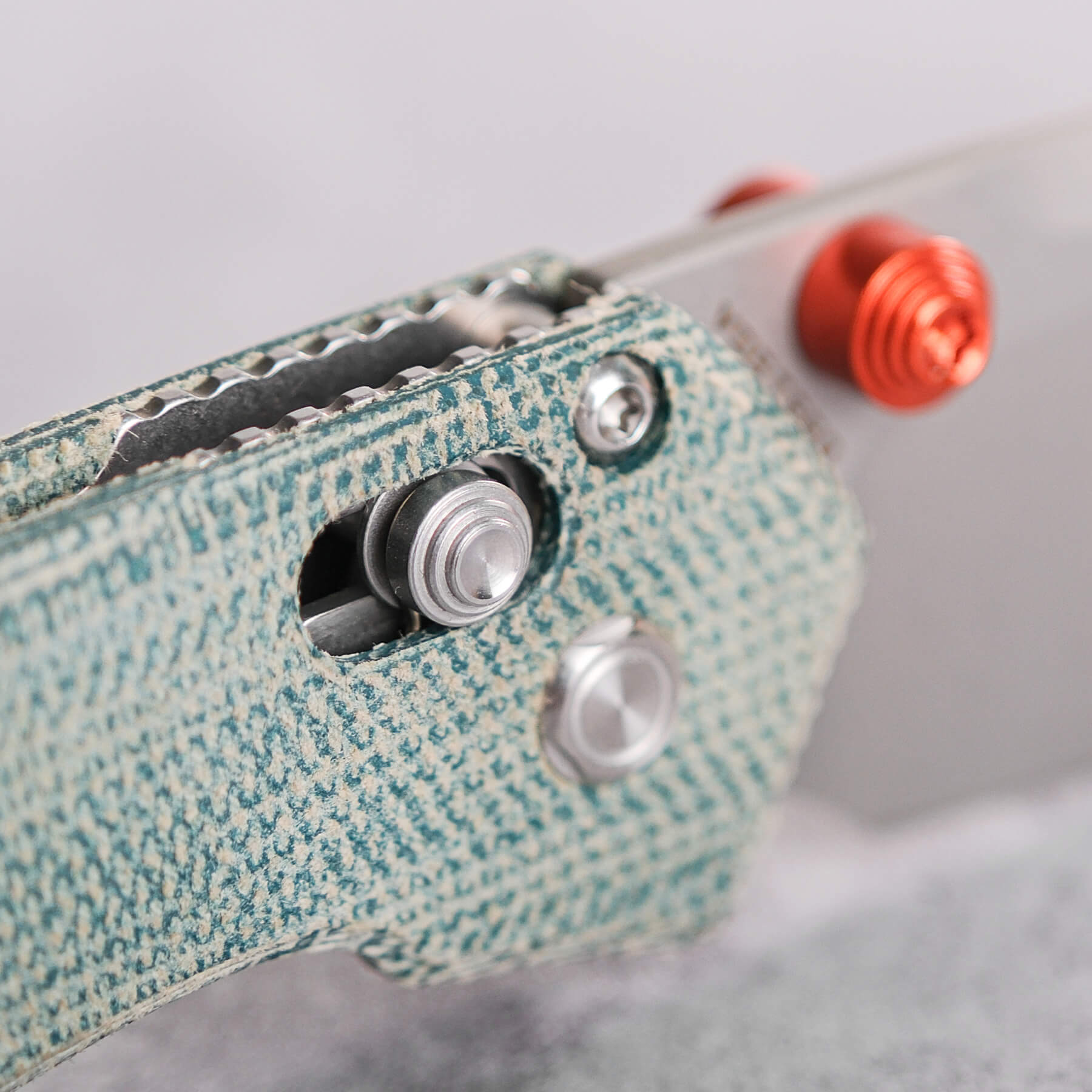 Vosteed Mini Psyop teal Micarta handle detail