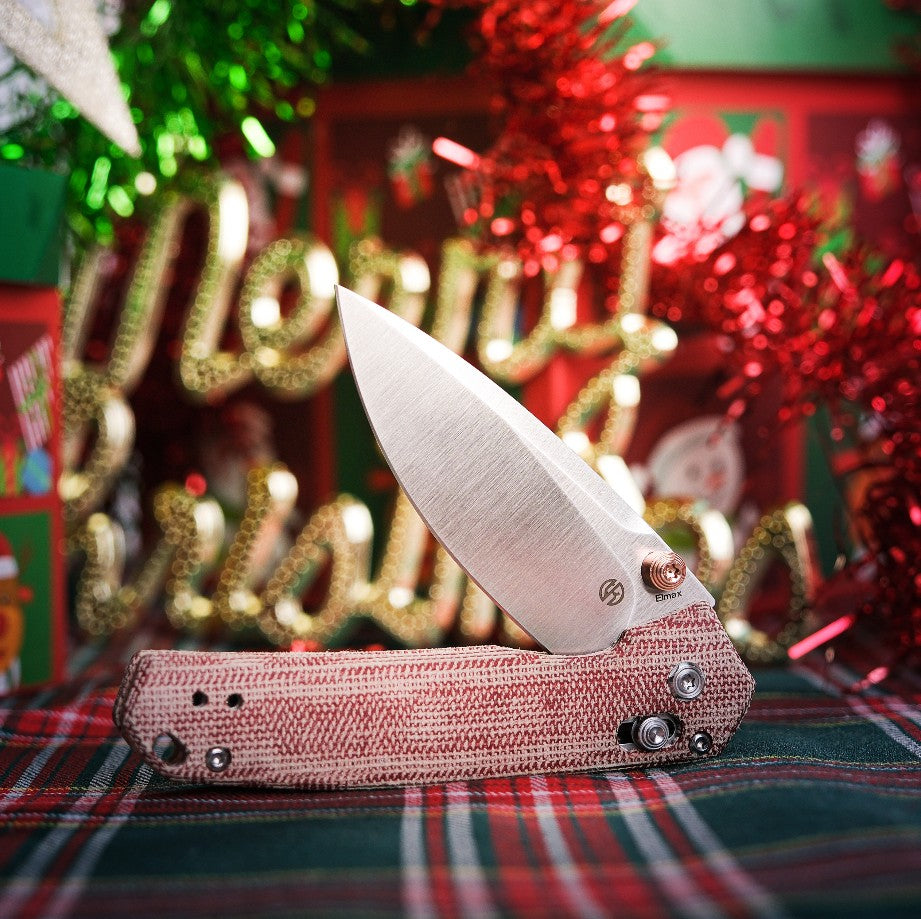 Mini Psyop red Micarta knife with Christmas background