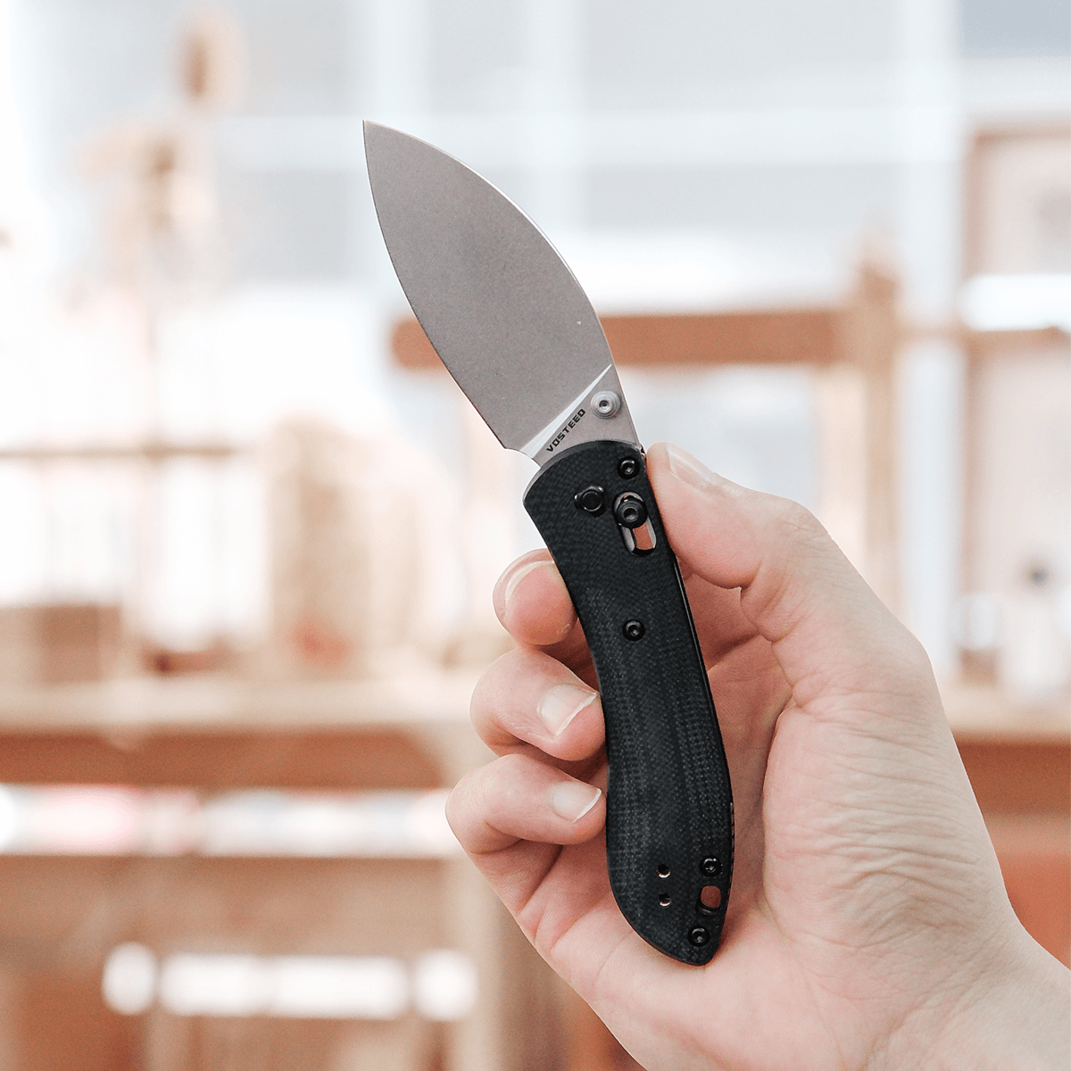 Vosteed Mini Nightshade knife held in hand, detail view