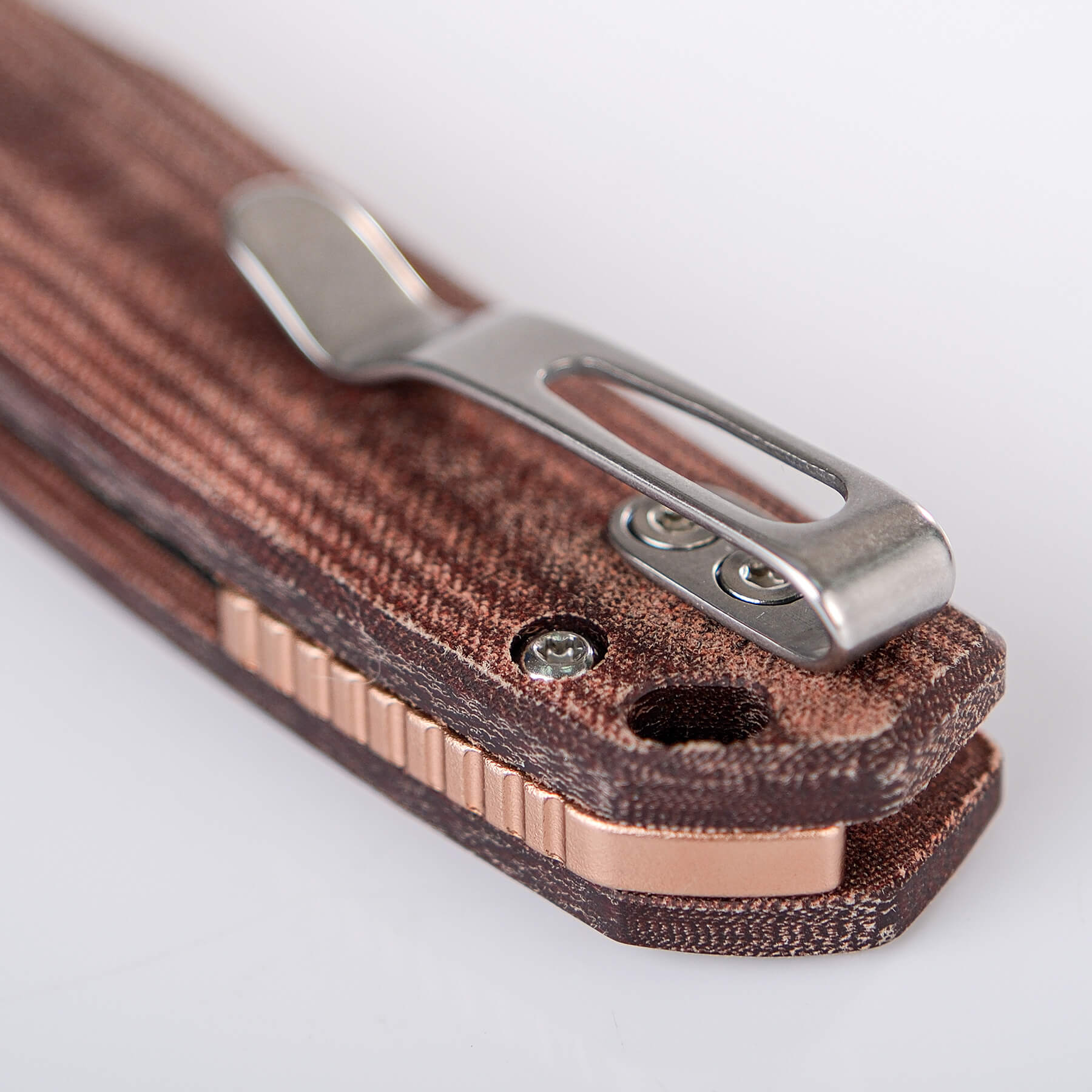 Mini Psyop knife: pocket clip, Micarta handle, and copper backspacer detail