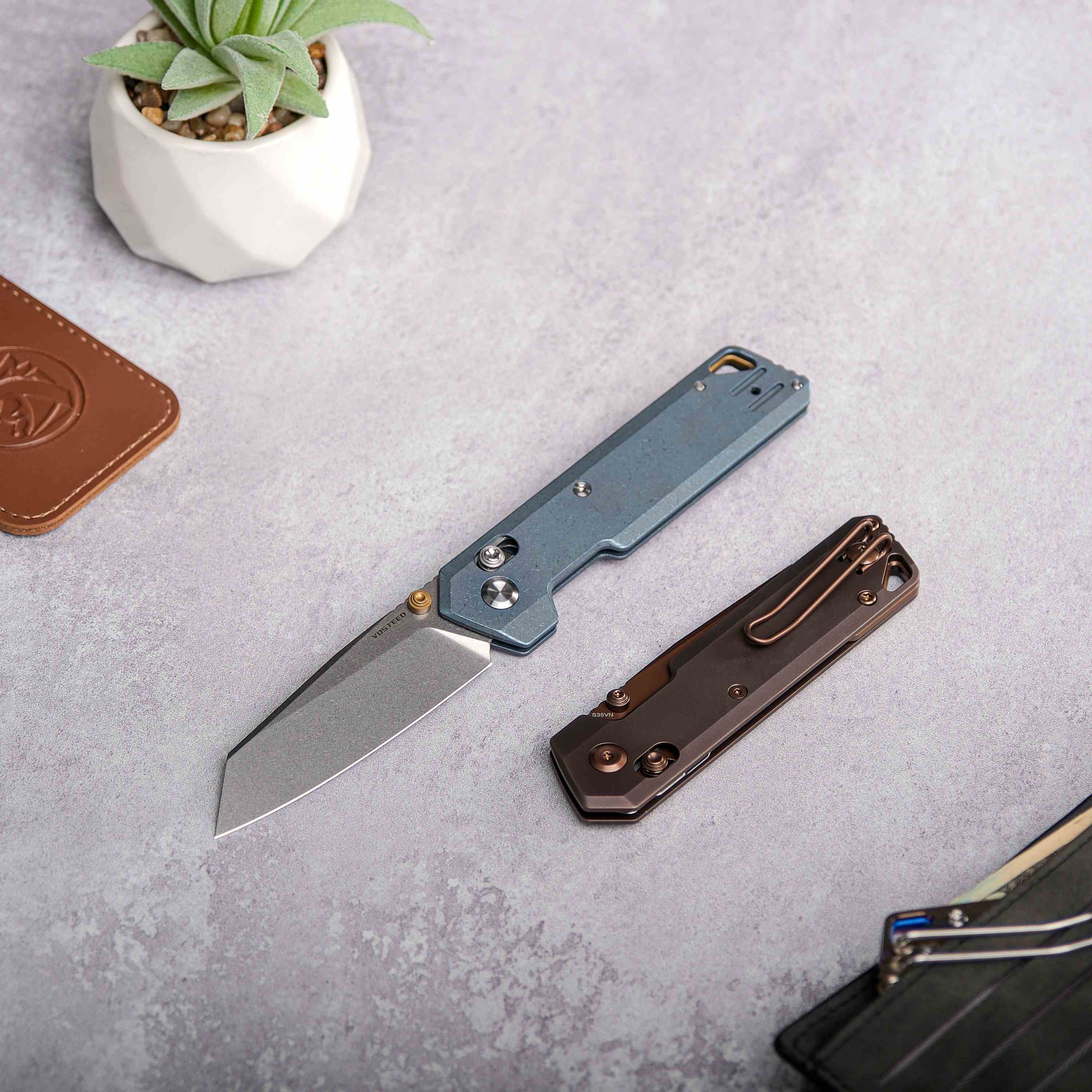 Vosteed Parallel Knife with Blue Titanium Handle on Table