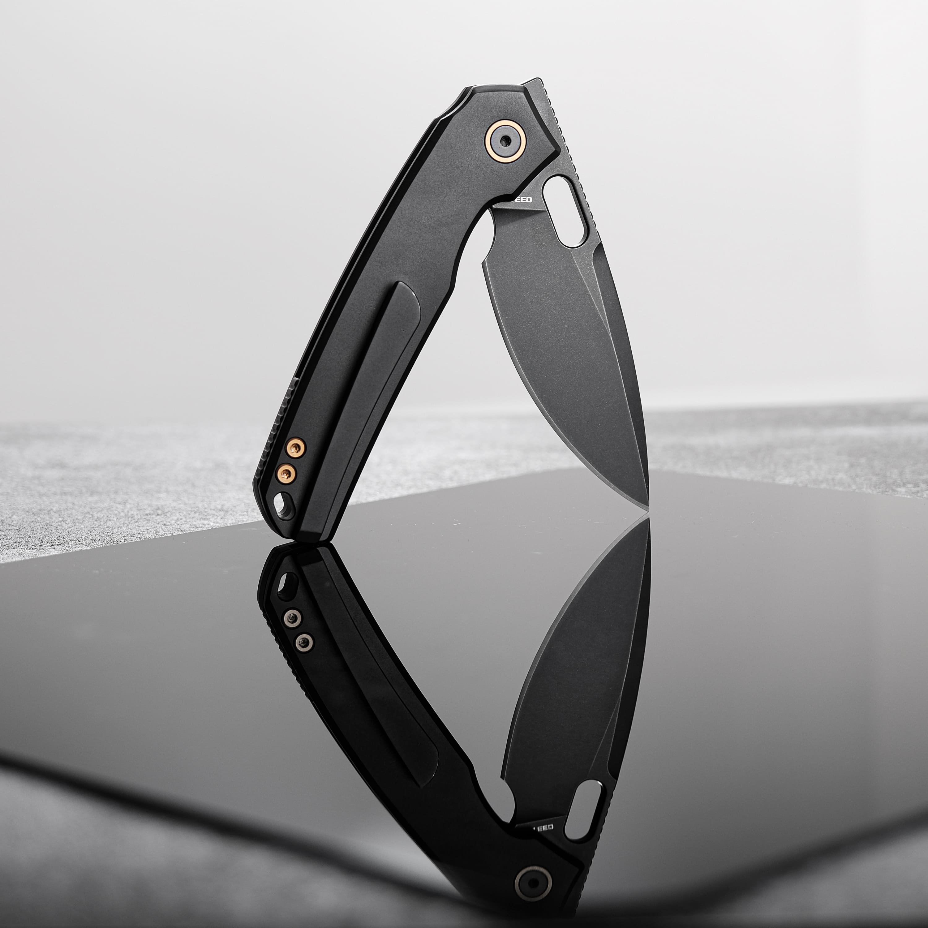 Vosteed Psyop knife, black blade and titanium handle, partially open