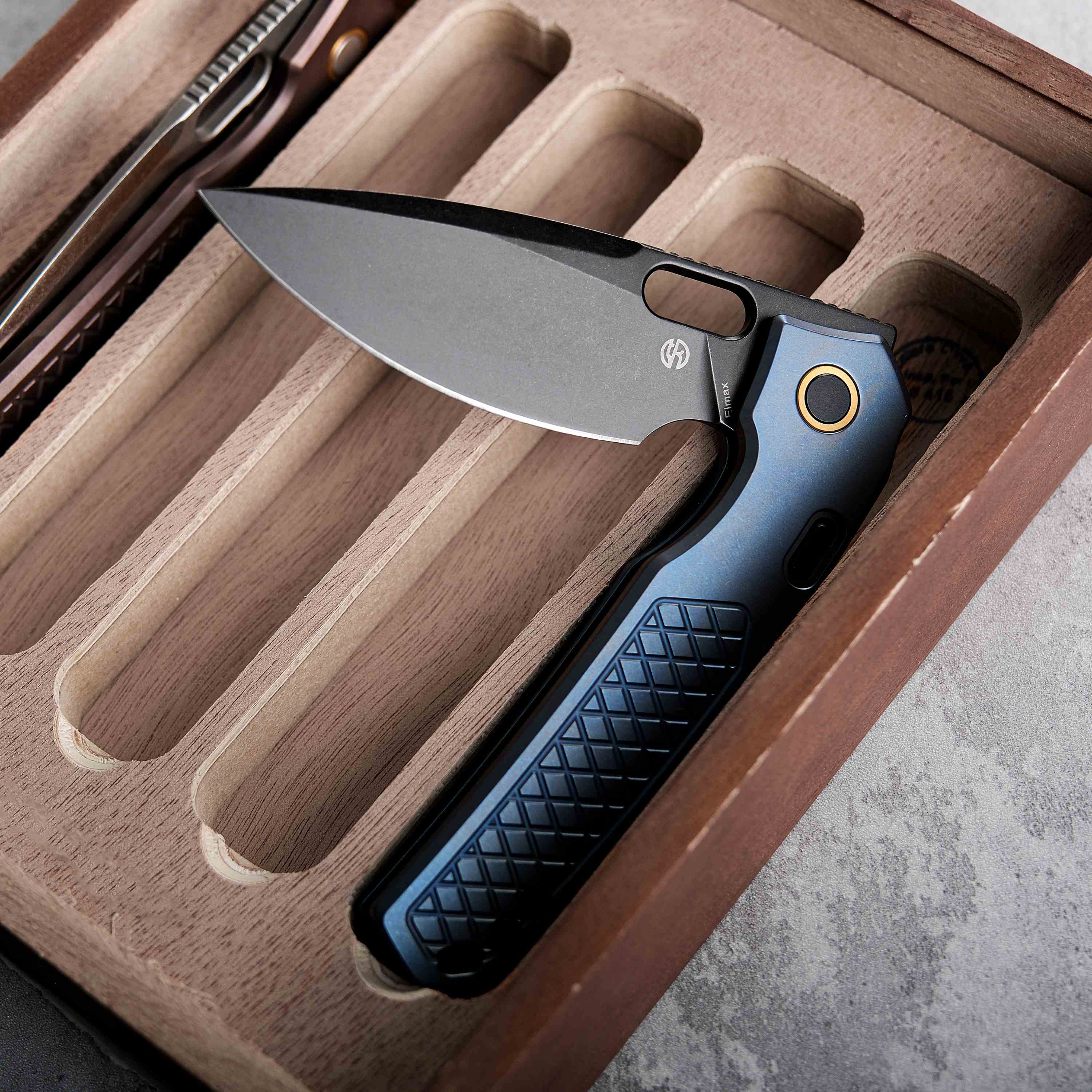 Vosteed Psyop knife, Elmax blade, blue titanium handle, in a wooden case