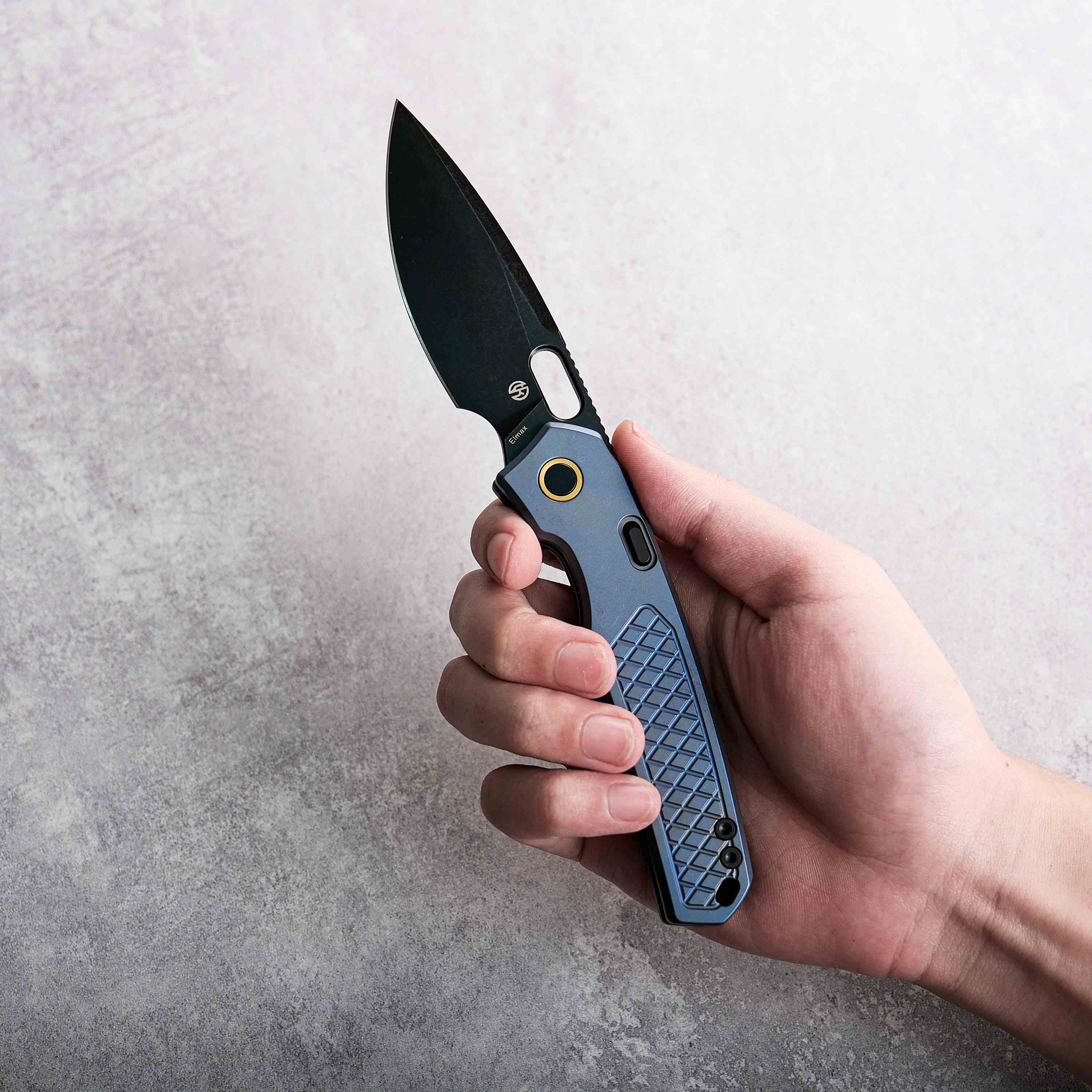 Vosteed Psyop knife with black Elmax blade and blue titanium handle