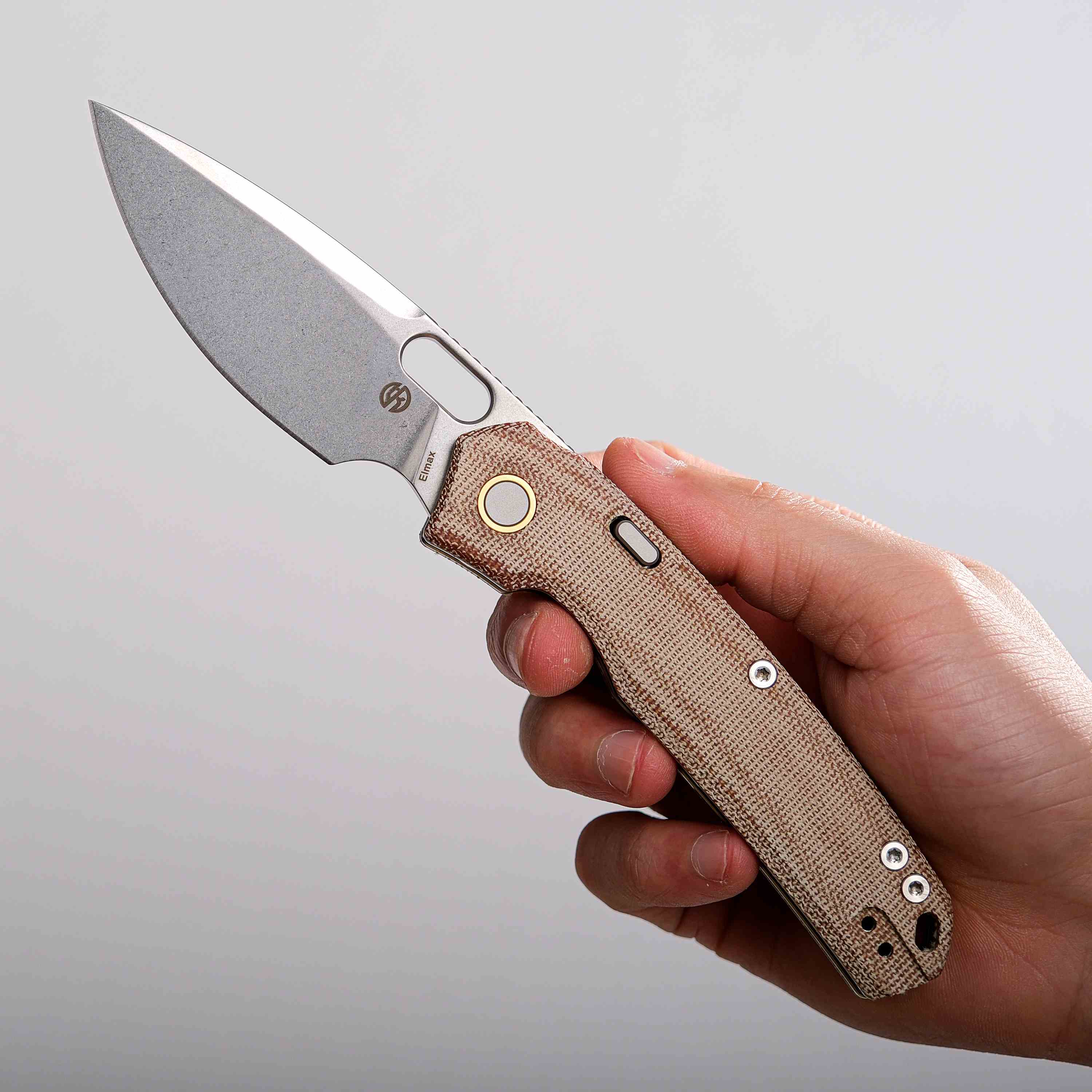 Vosteed Psyop knife in hand, natural Micarta handle