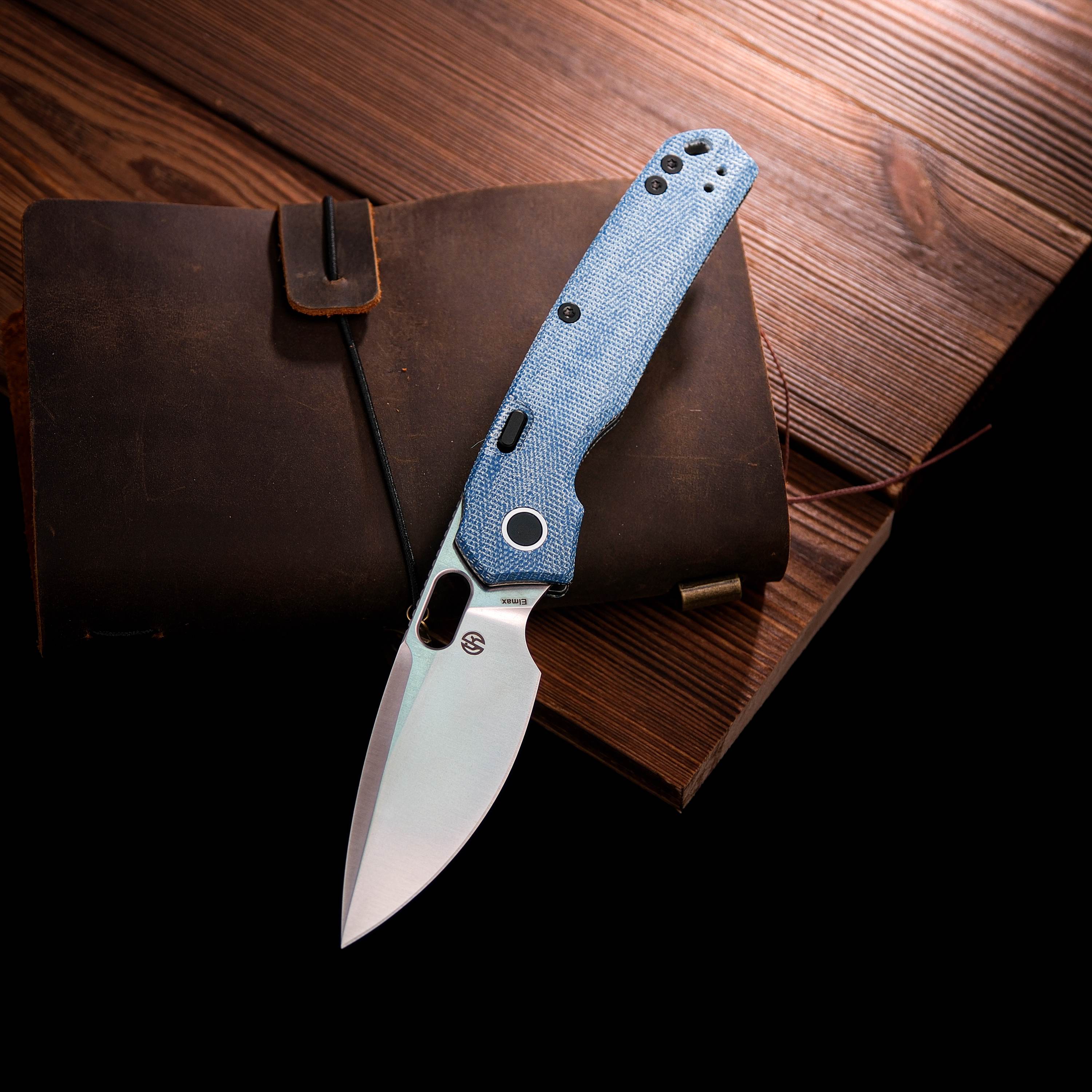 Vosteed Psyop knife on leather notebook, blue Micarta handle