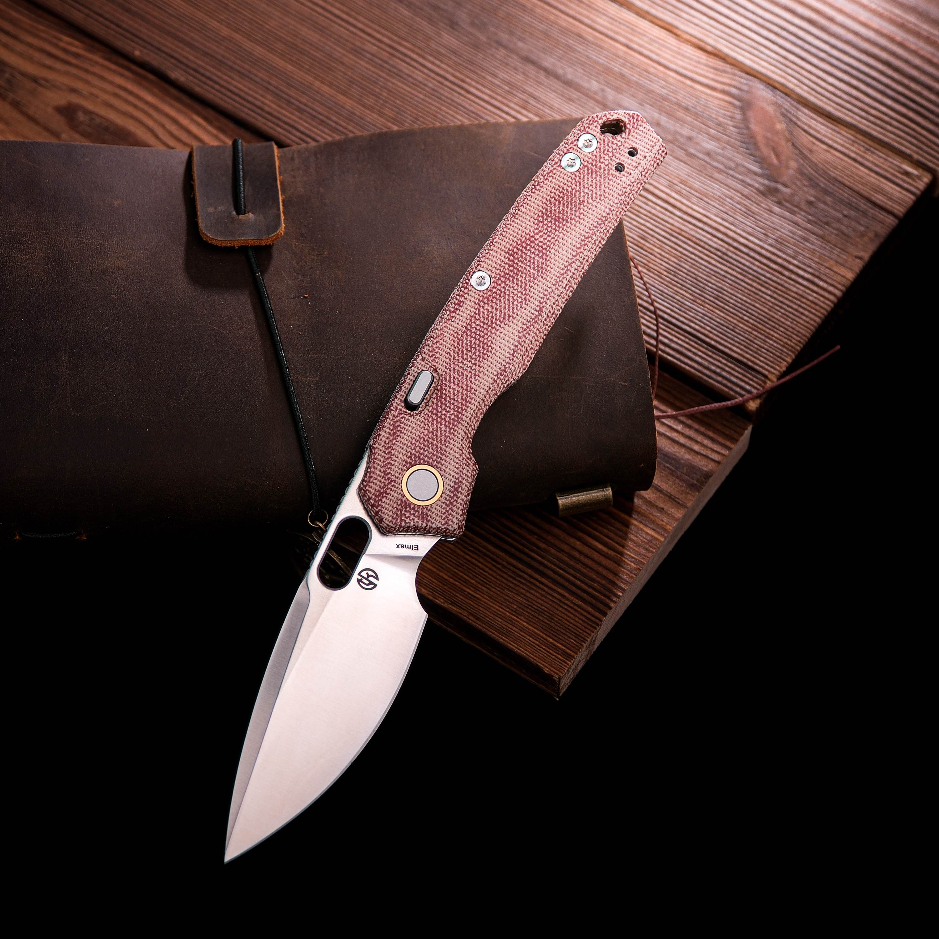 Vosteed Psyop knife with red Micarta handle, open blade