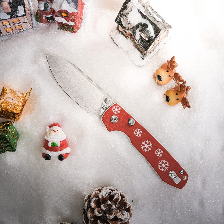 Vosteed Raccoon Christmas Knife on snow