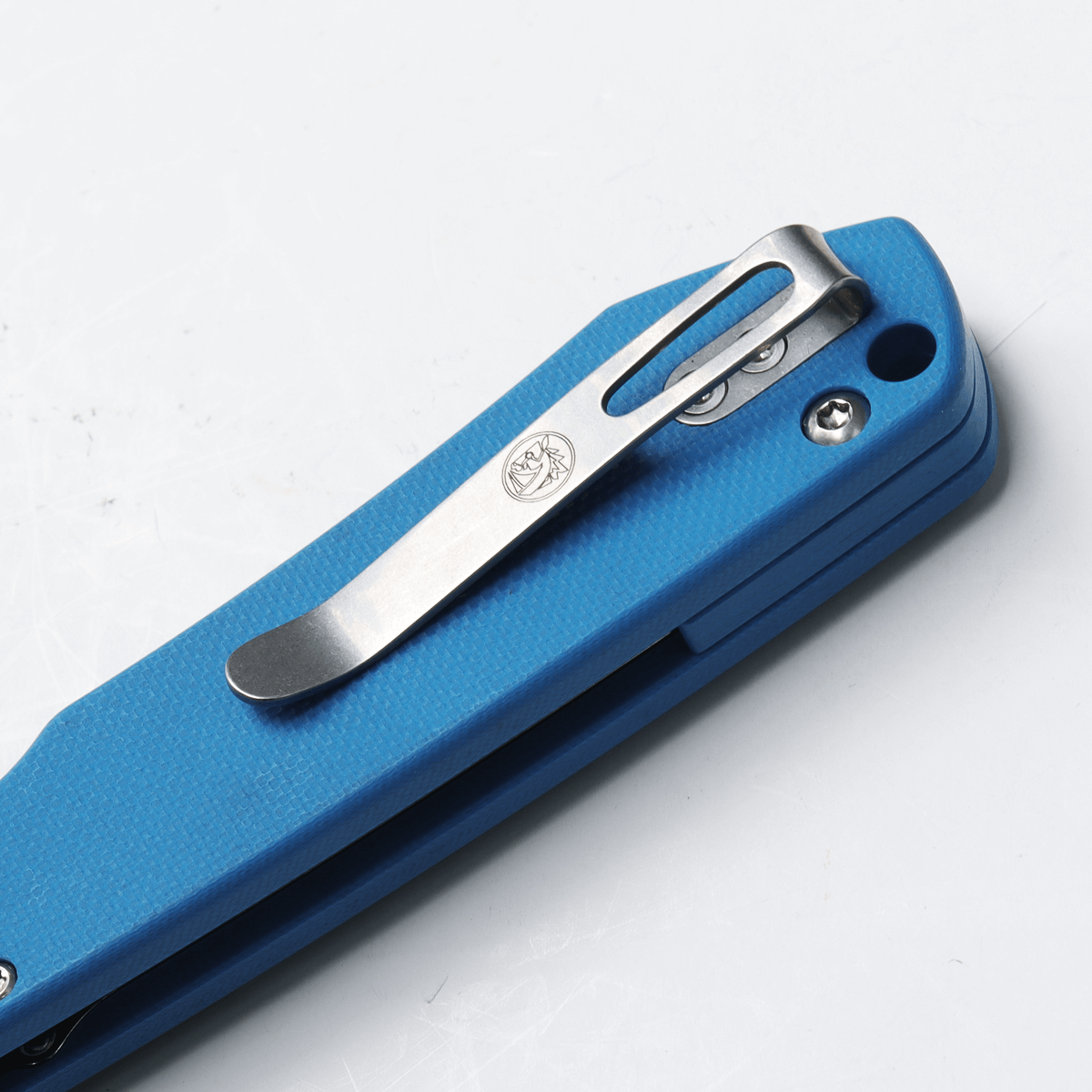 Vosteed Raccoon knife pocket clip detail, blue G10 handle